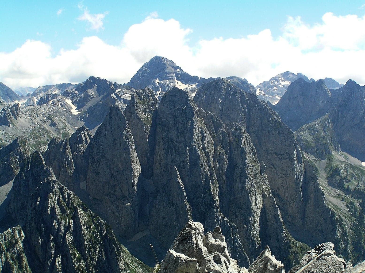 Snowy jagged peaks of the Albanian Alps under a blue sky
