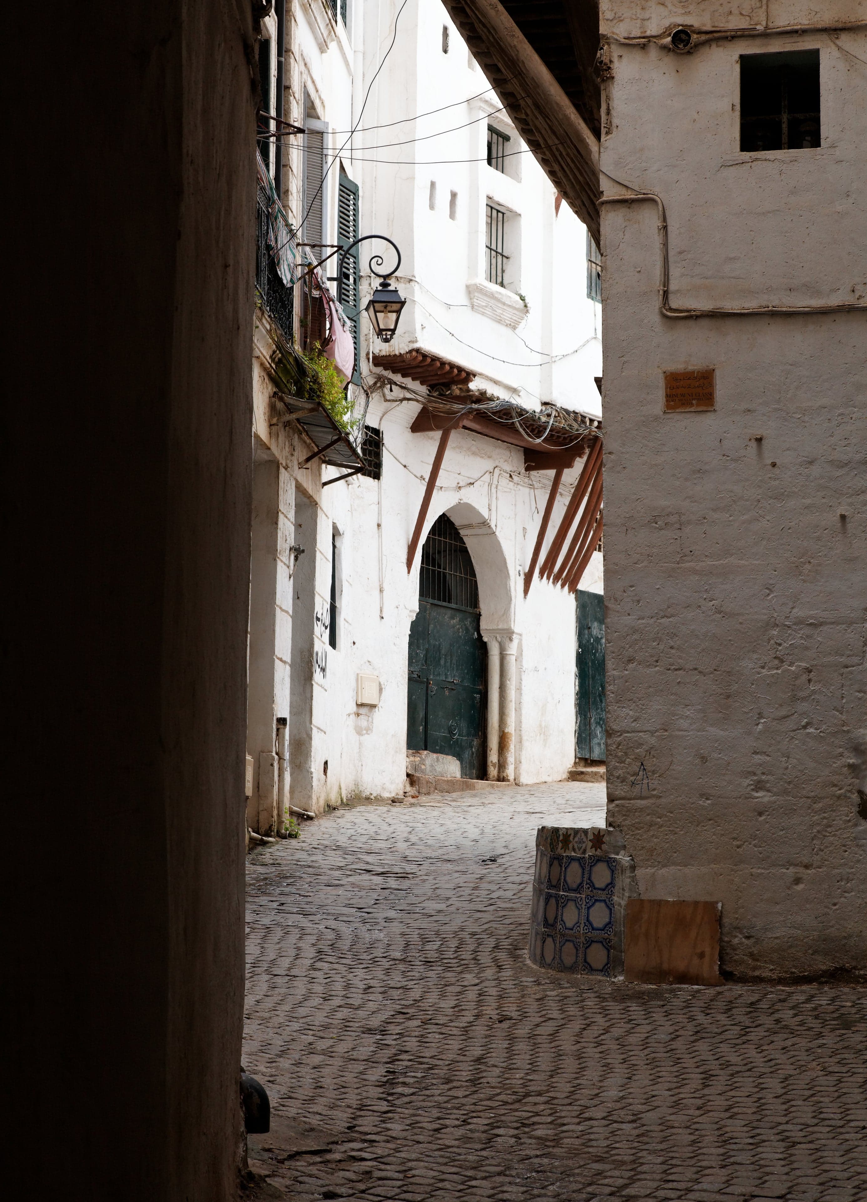 White-walled buildings of the Casbah of Algiers stacked on a hillside above the Mediterranean