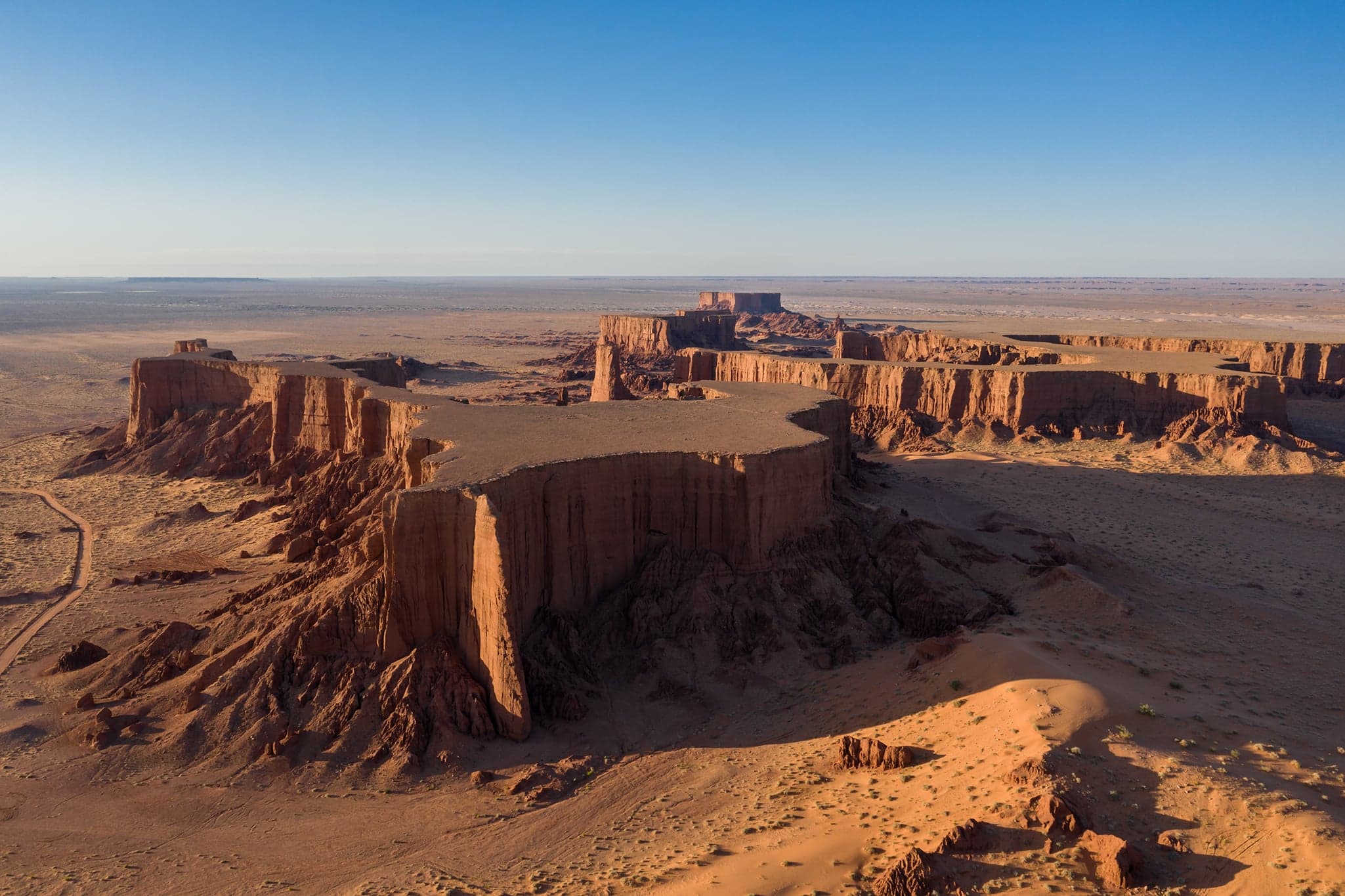 Tall orange sand dunes stretching across the Algerian Sahara