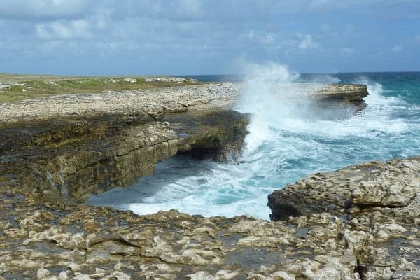 The natural limestone arch of Devil's Bridge on Antigua's Atlantic coast