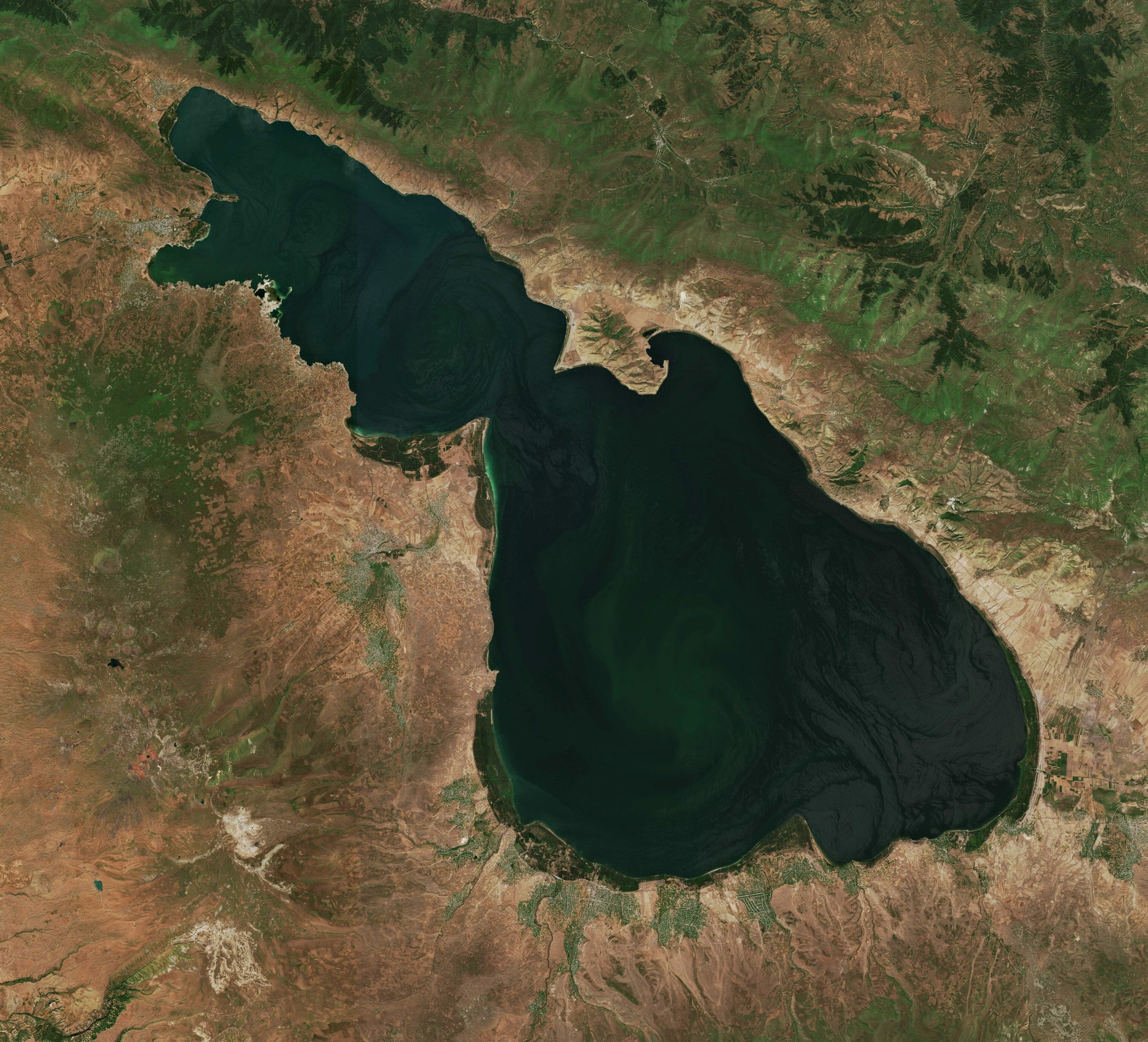 The blue water of Lake Sevan with mountains behind it