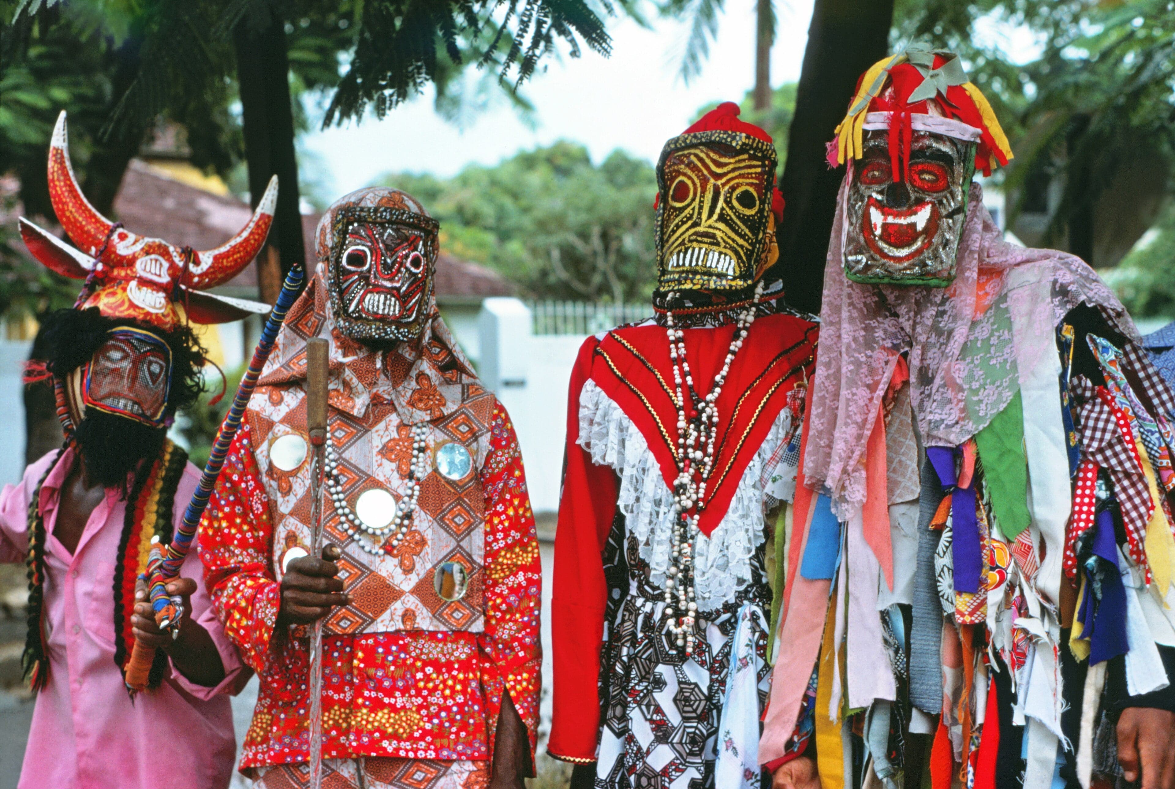 Dazzling Junkanoo parade costumes in gold, red, and blue with feathers and sequins