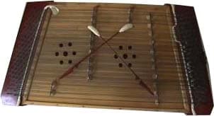 A tsymbaly hammered dulcimer with two small wooden mallets resting on its strings