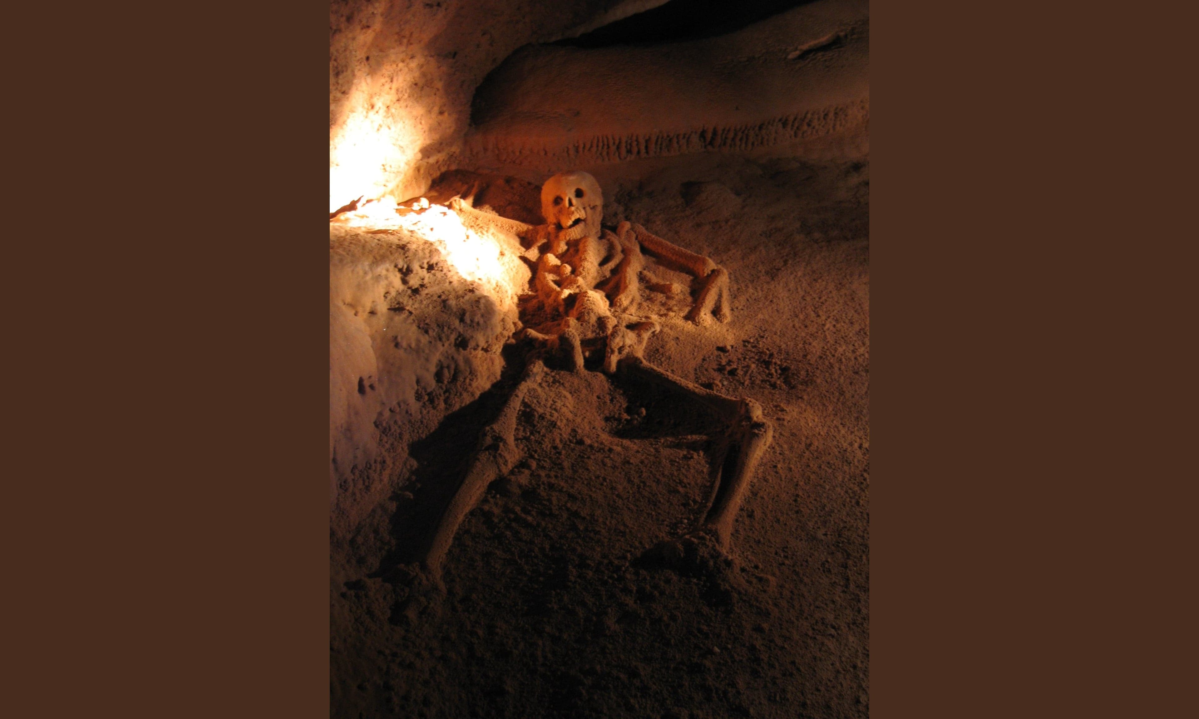 Inside the ATM cave, sparkling crystal formations glitter in the lamplight