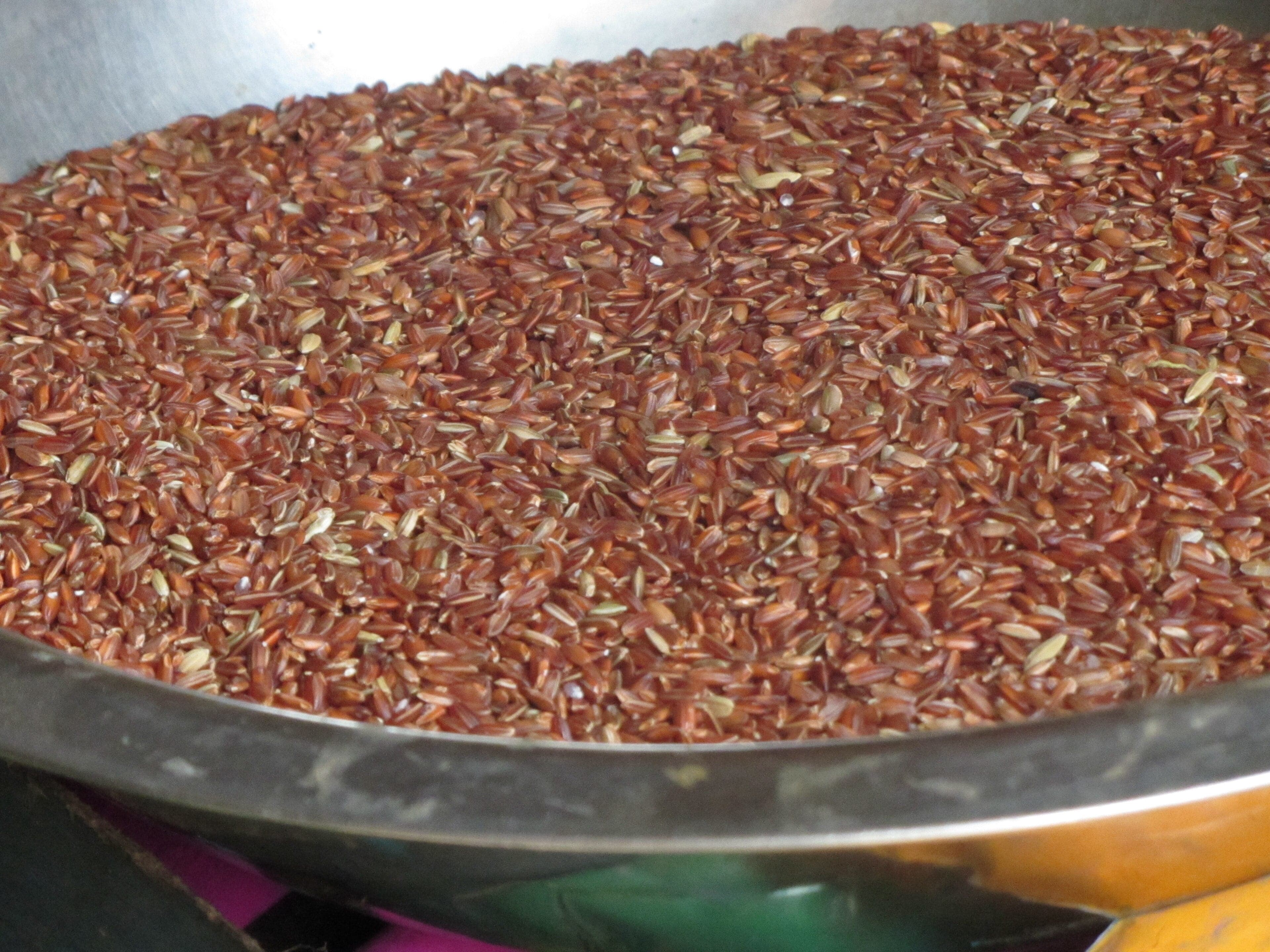 A bowl of cooked Bhutanese red rice with a reddish-brown colour and fluffy texture