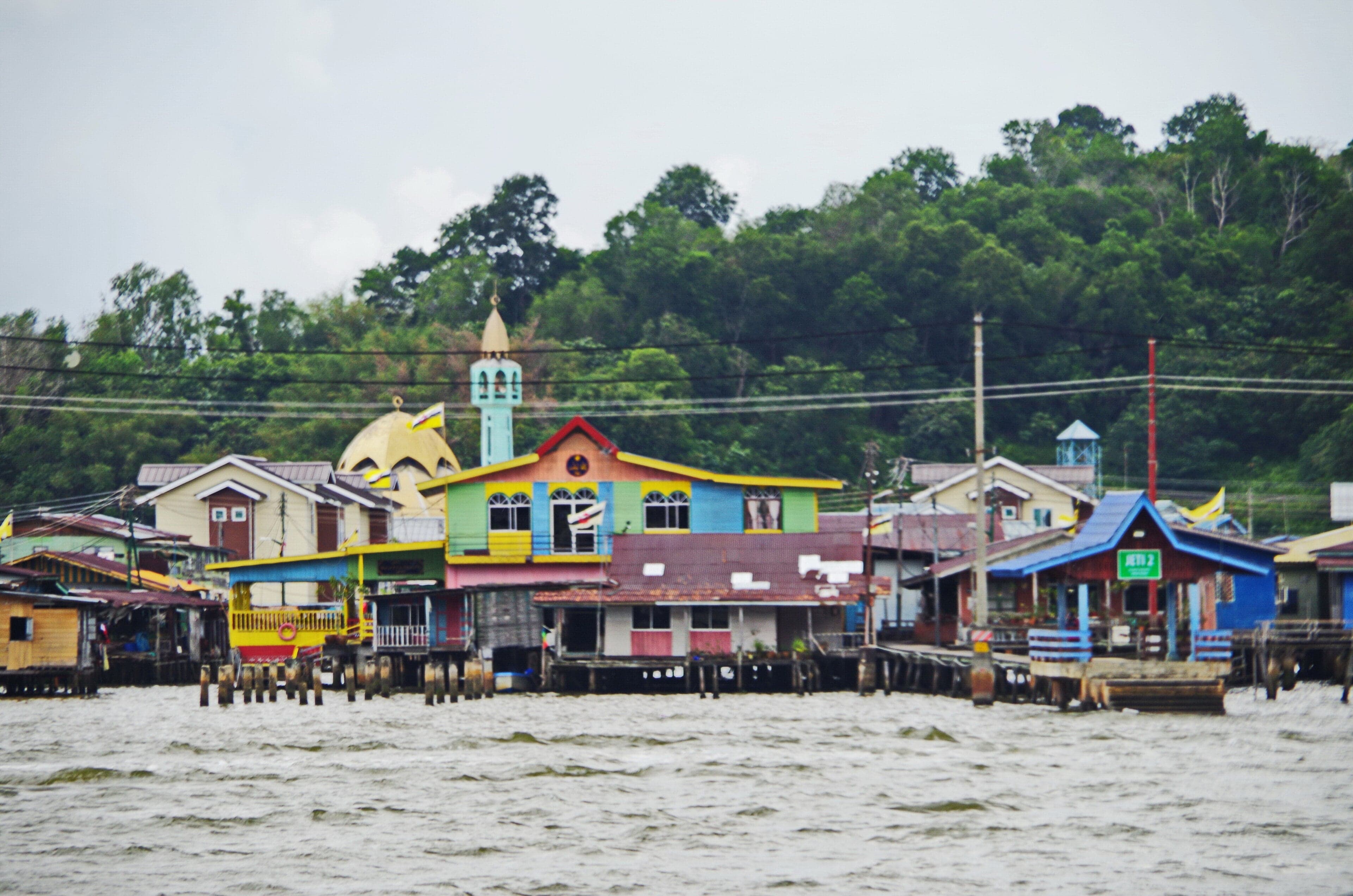 Colourful houses on stilts above the Brunei River at sunrise