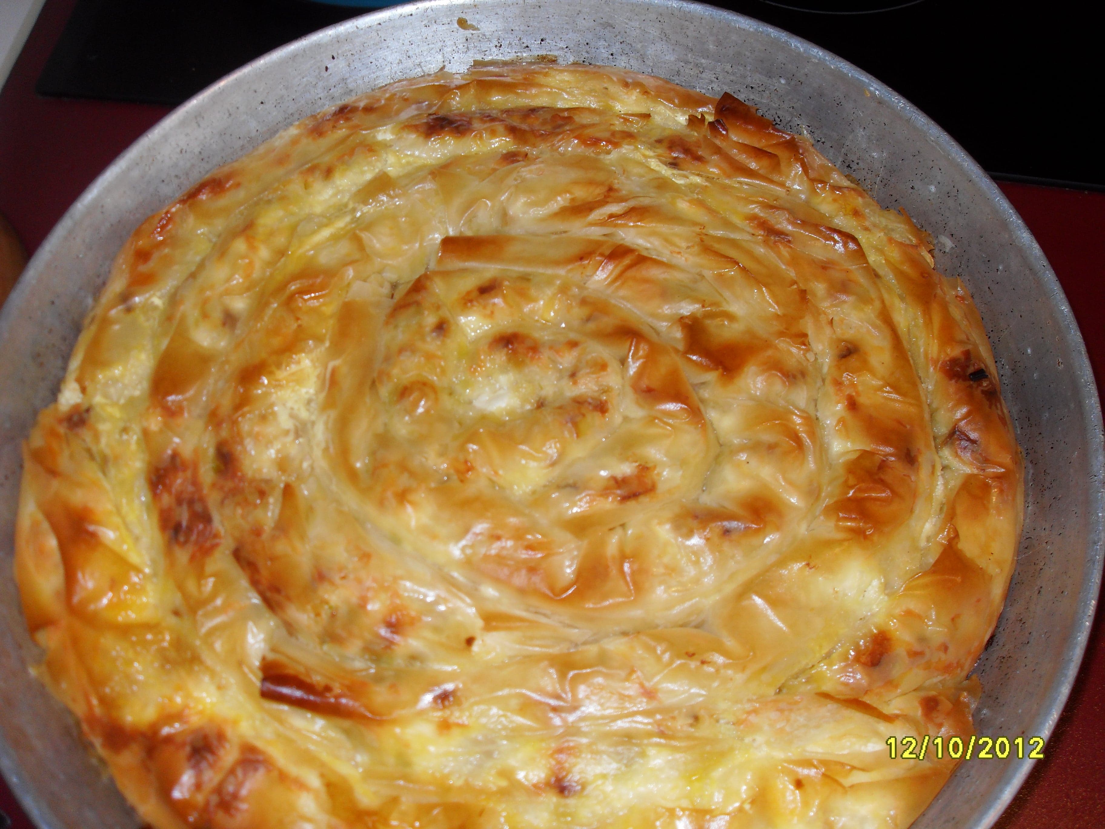 Golden-brown spiral pastry banitsa pieces on a plate