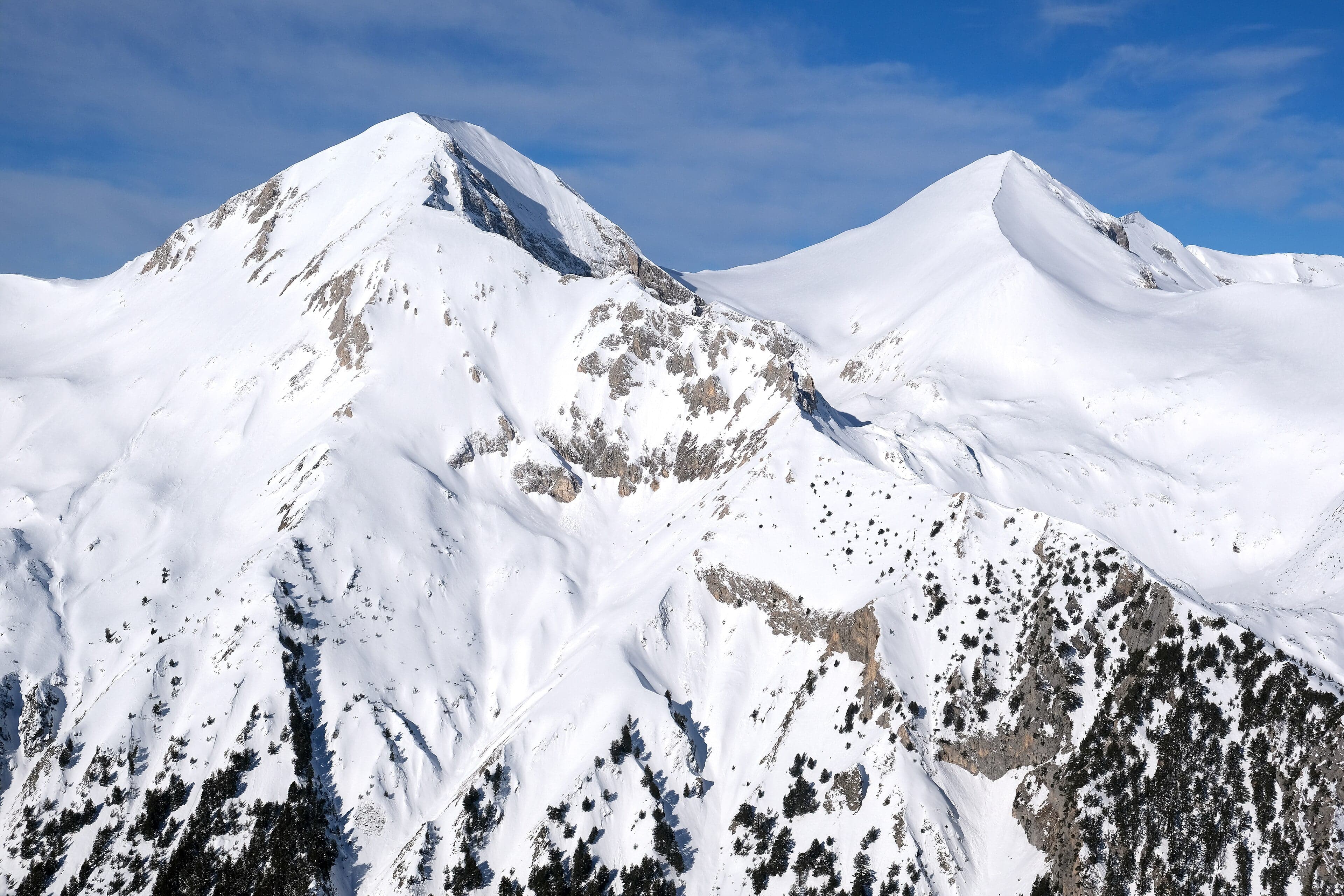 Rocky peaks and a glacier lake in Bulgaria's Pirin Mountains under a blue sky