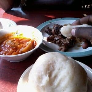 A bowl of ugali porridge next to a plate of boko boko wheat porridge