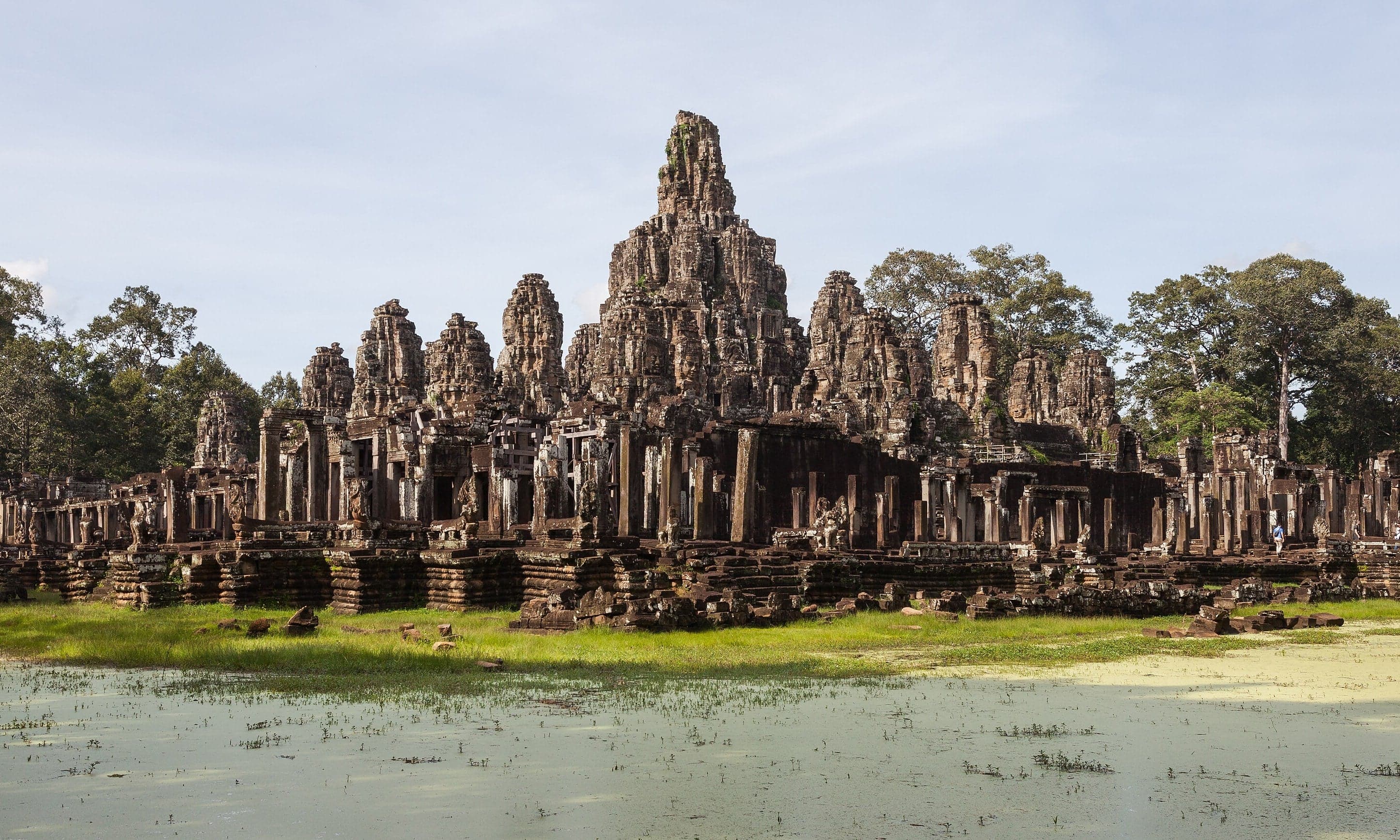 Giant stone faces smiling from the towers of the Bayon temple
