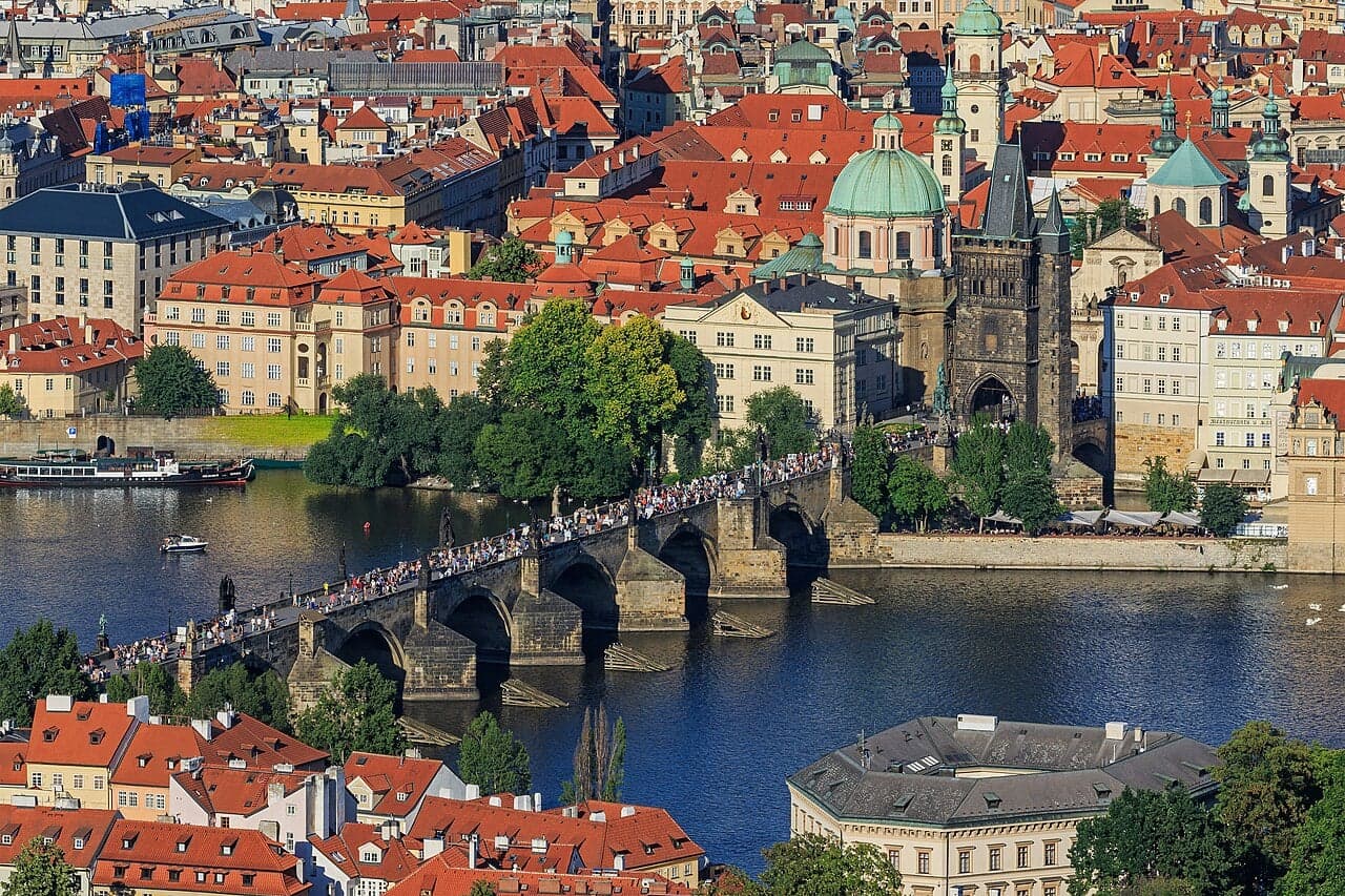 Charles Bridge with its baroque statues stretching across the Vltava River at dawn
