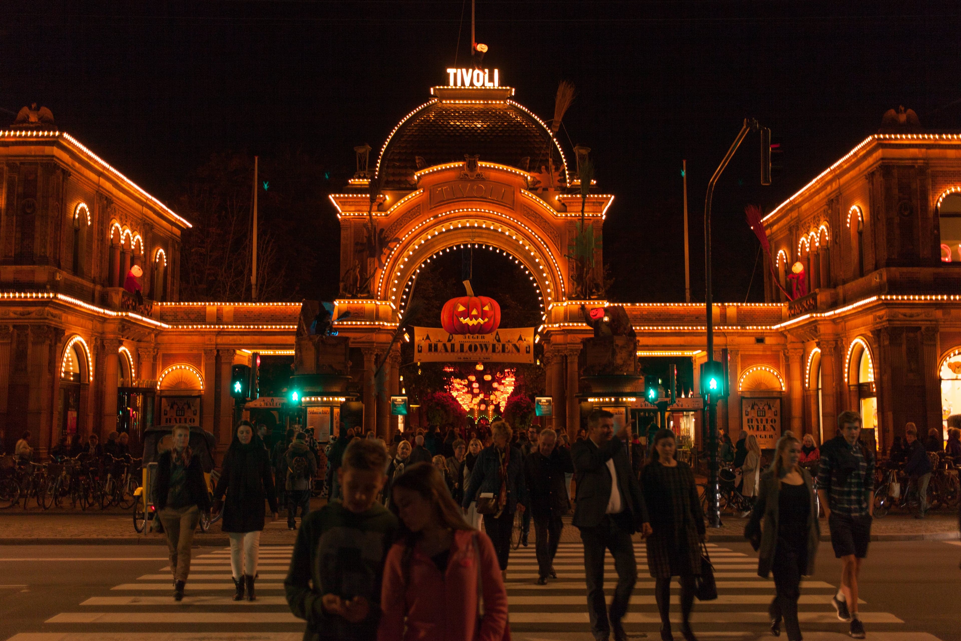 Twinkling lights and rides at Tivoli Gardens in Copenhagen at dusk