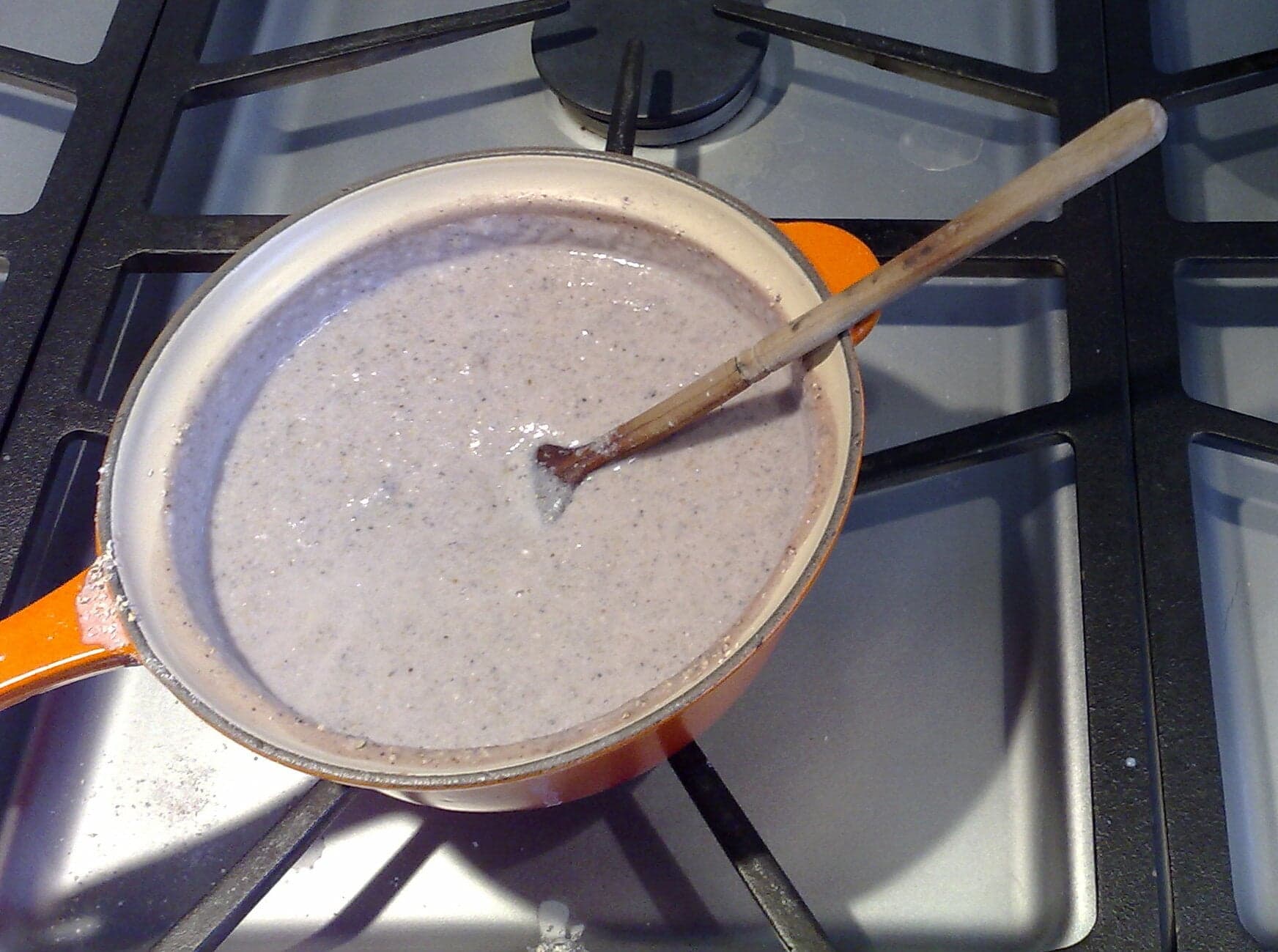 A cup of creamy atol de elote, a warm corn and milk drink