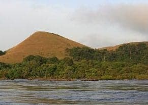 Rolling green hills of Lopé National Park with rainforest in the background