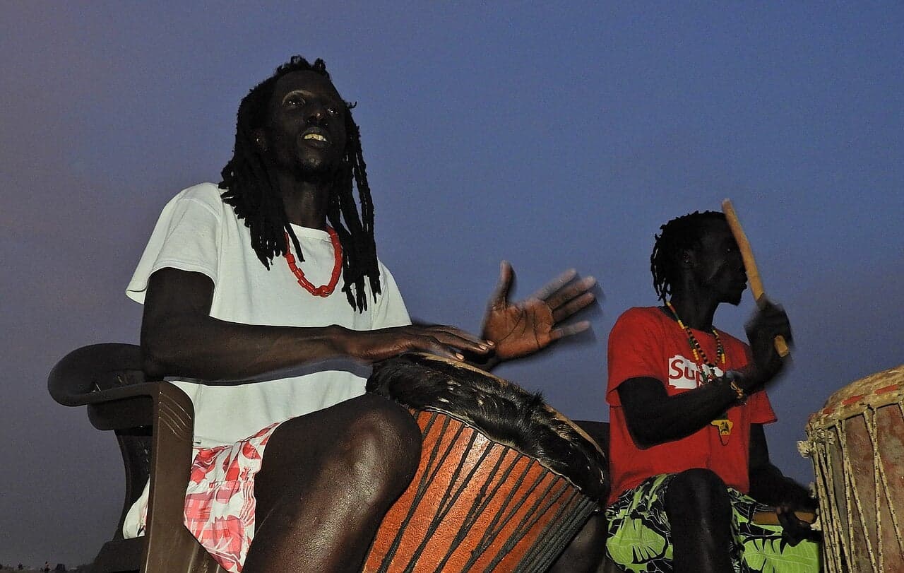 Colourful dancers and drummers performing at the Roots Festival in Gambia