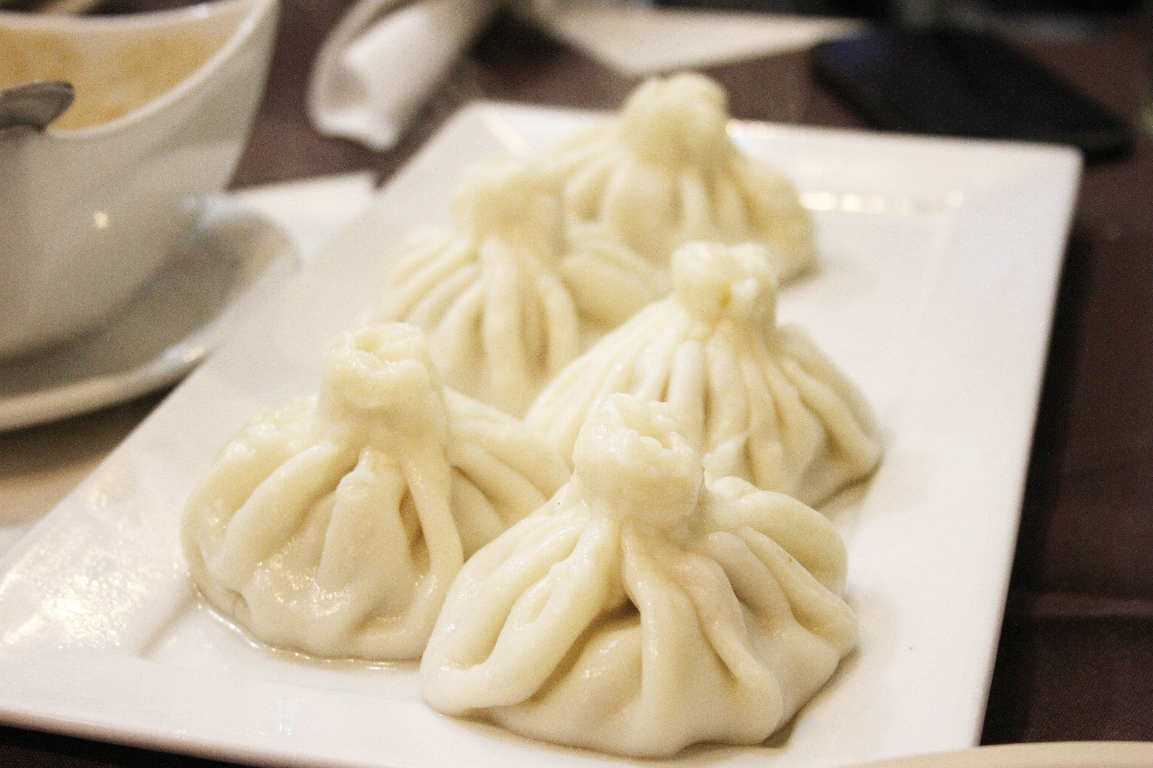 A pile of freshly steamed khinkali dumplings with their distinctive twisted tops