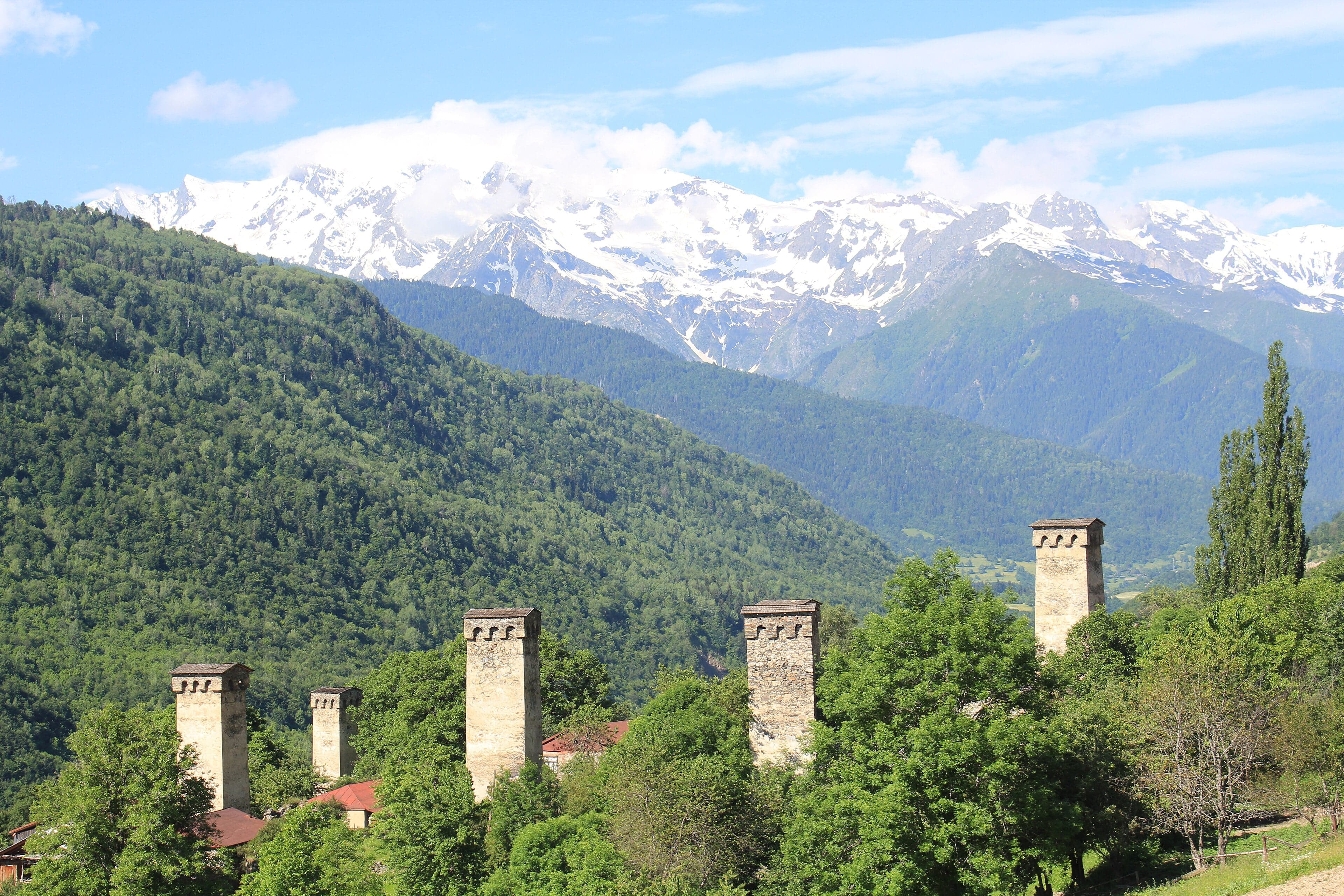 Tall stone medieval towers rising above a mountain village in Svaneti, Georgia