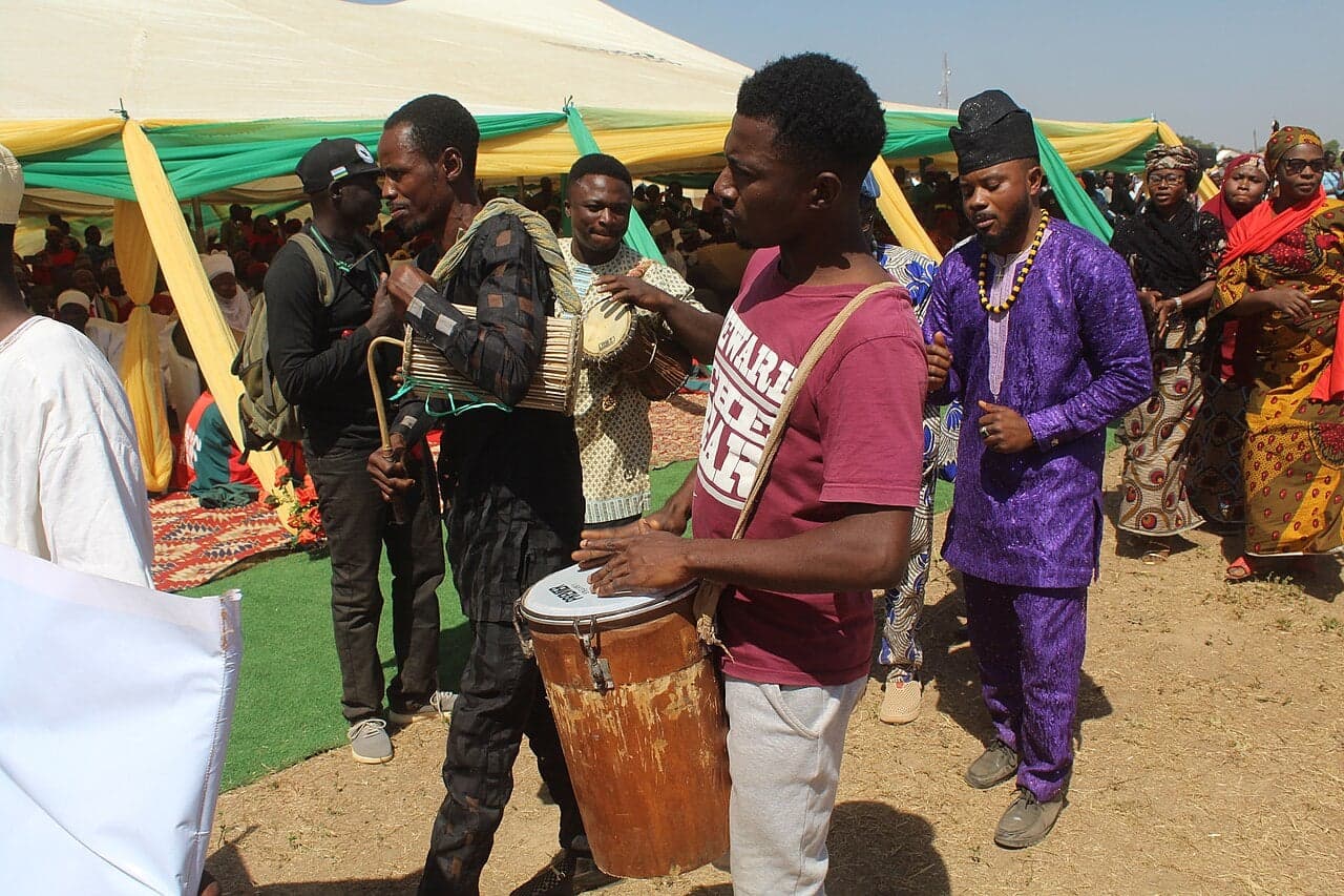 Drummers and dancers in traditional dress performing at the Carriacou Maroon Festival