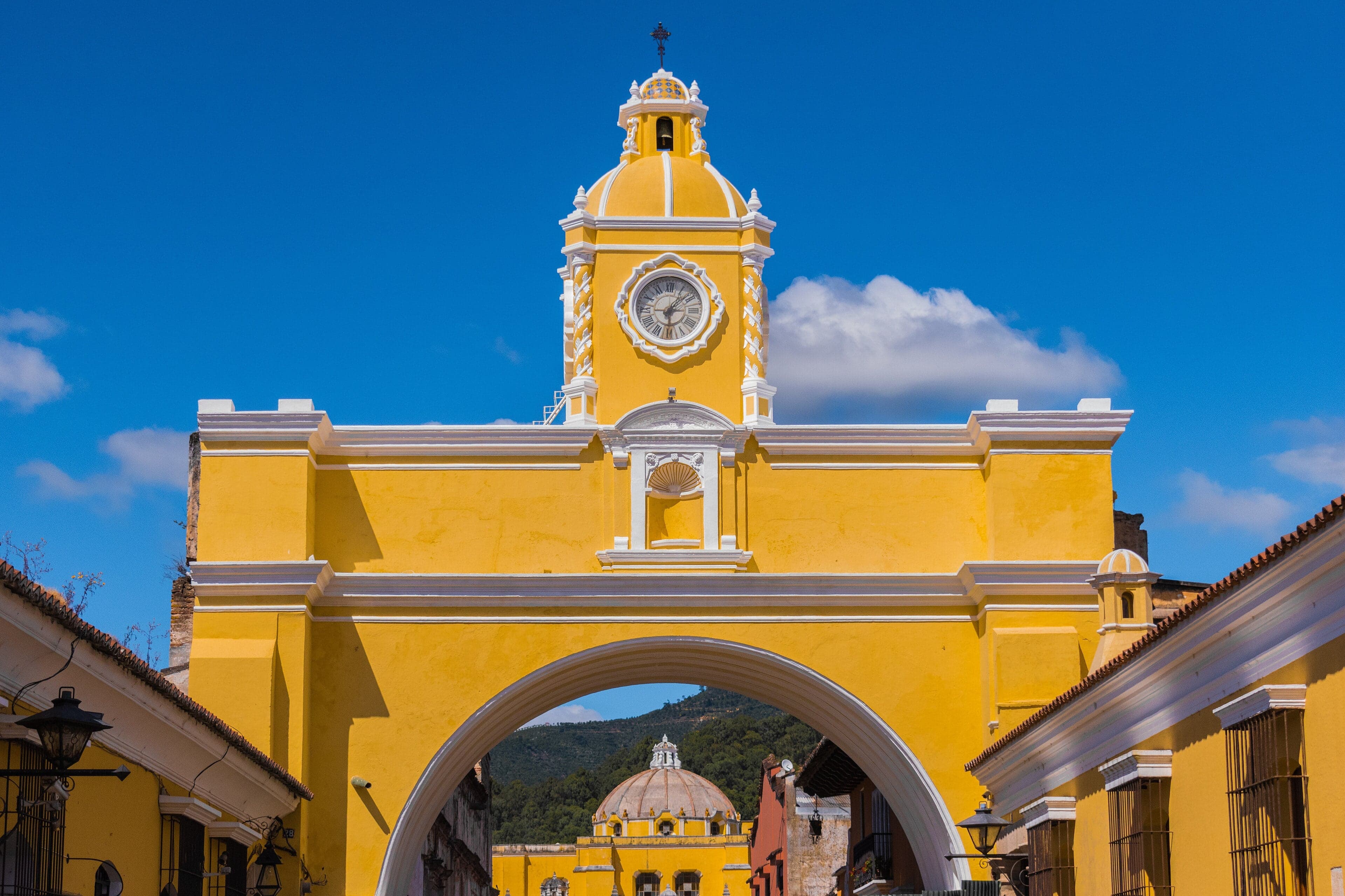 Colourful colonial buildings lining a cobblestone street in Antigua, Guatemala