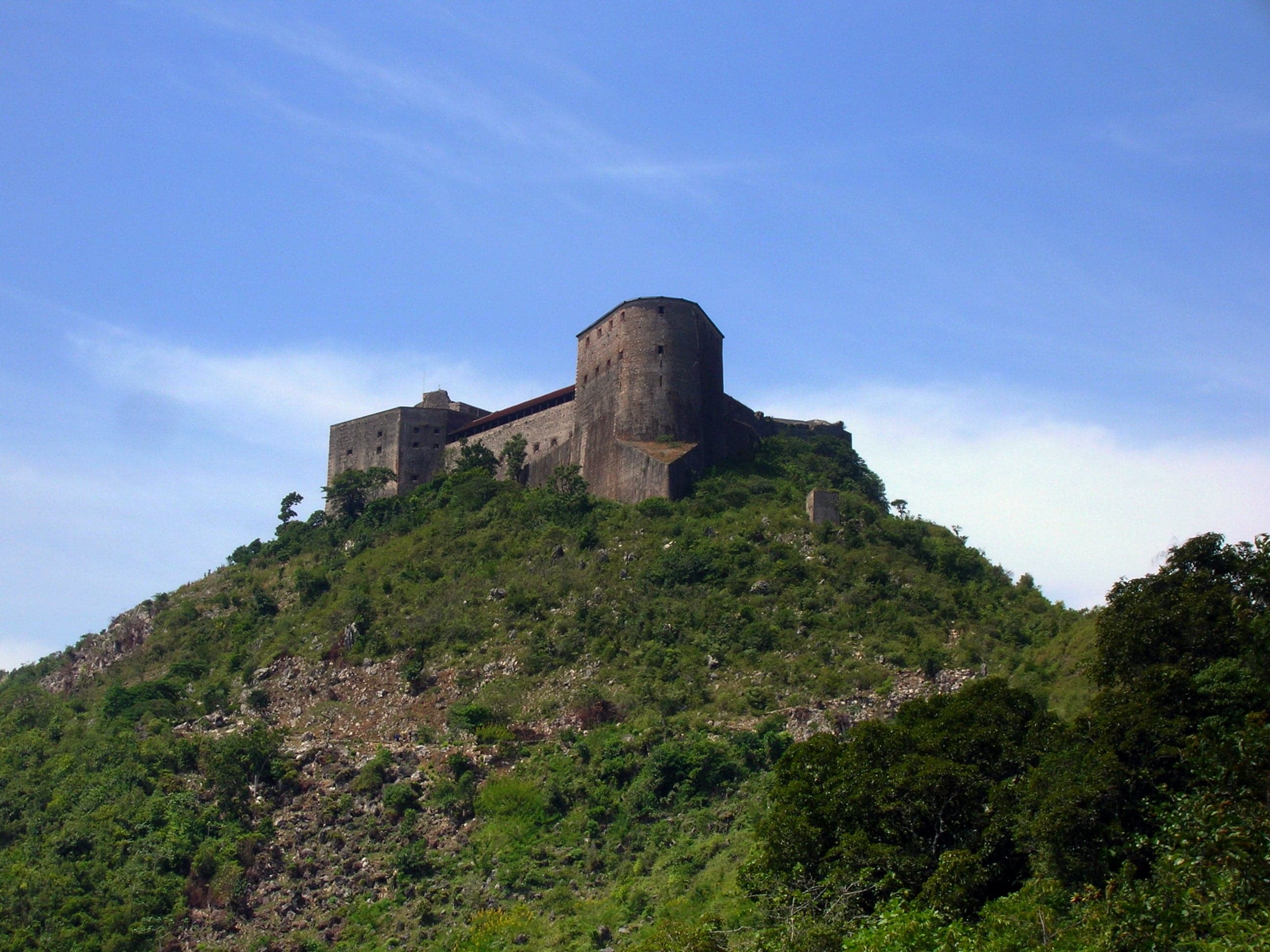 The massive stone walls of Citadelle Laferrière rising above green mountain slopes