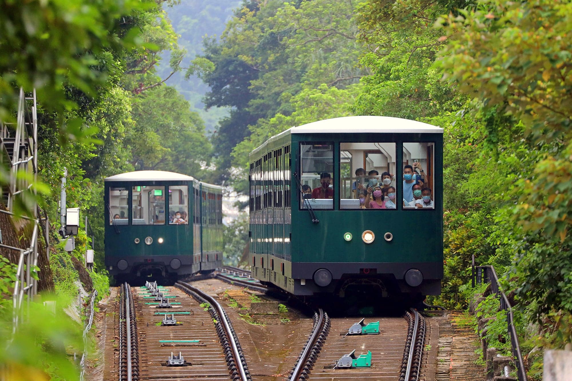 The Peak Tram car climbing steeply up the hillside above Hong Kong
