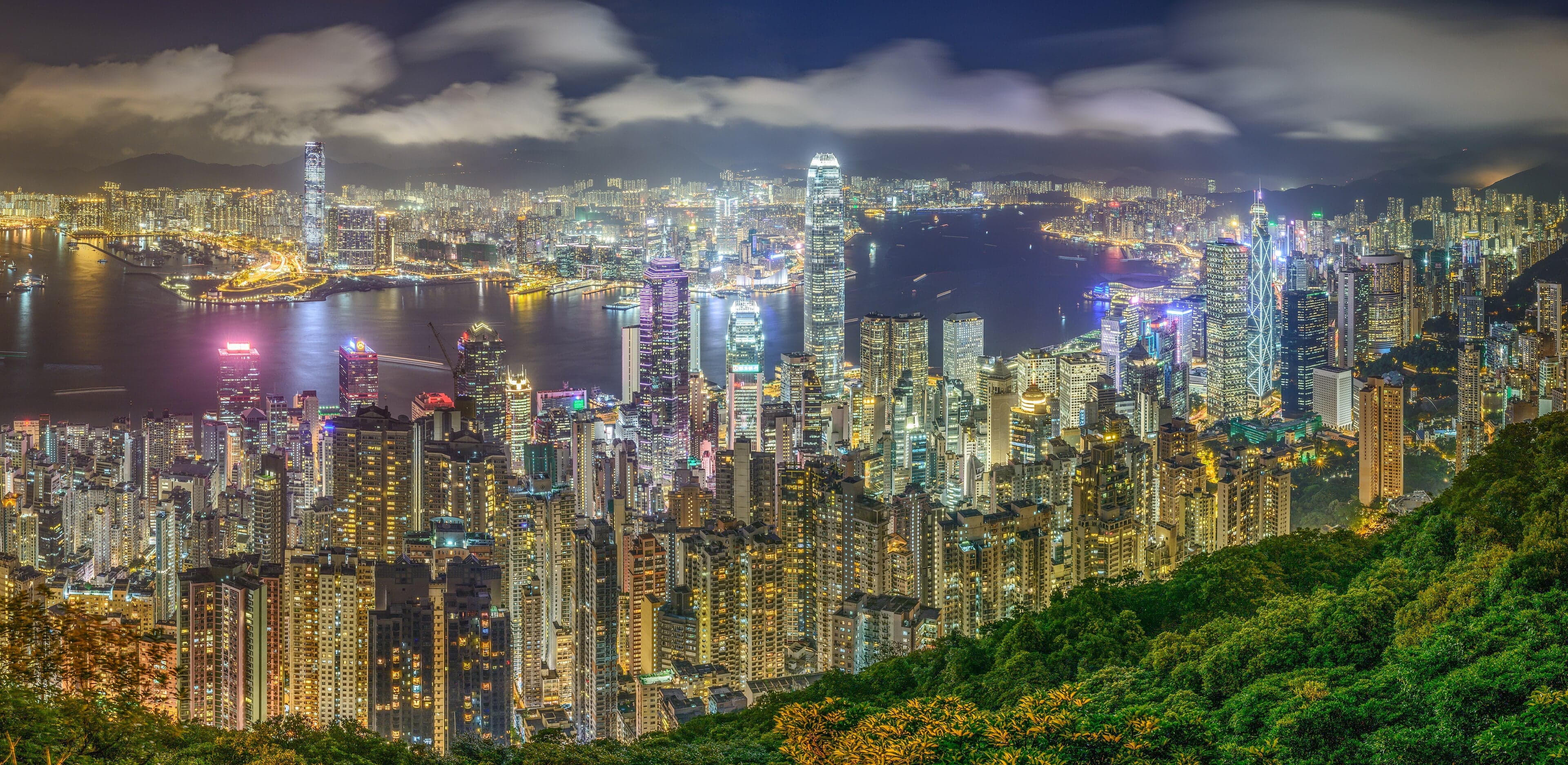 The Hong Kong skyline at night reflected in Victoria Harbour