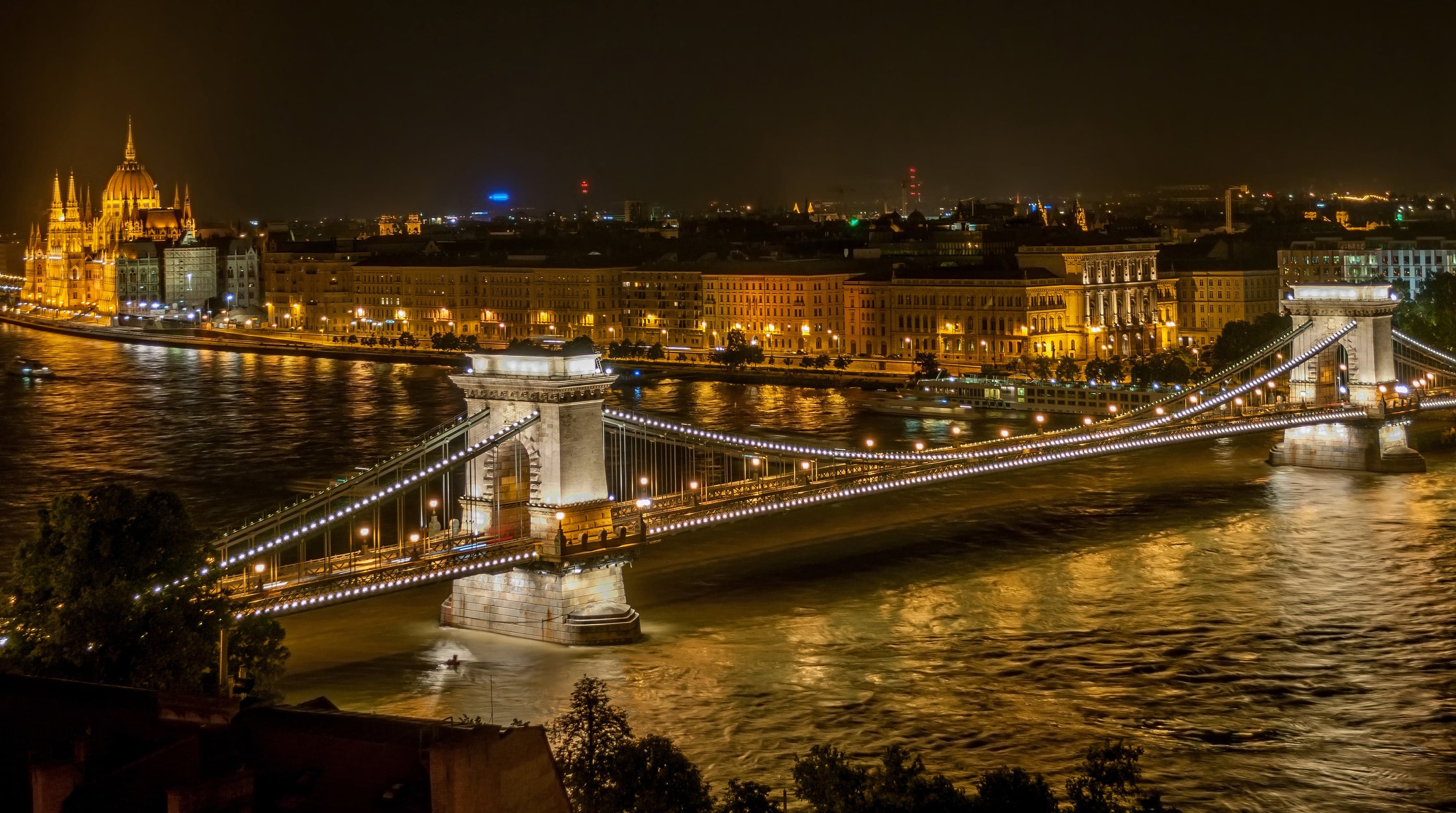 Budapest's Chain Bridge lit up at night with Parliament in the background