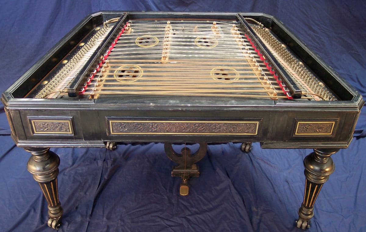 A musician playing a cimbalom with small hammers at a Hungarian folk concert