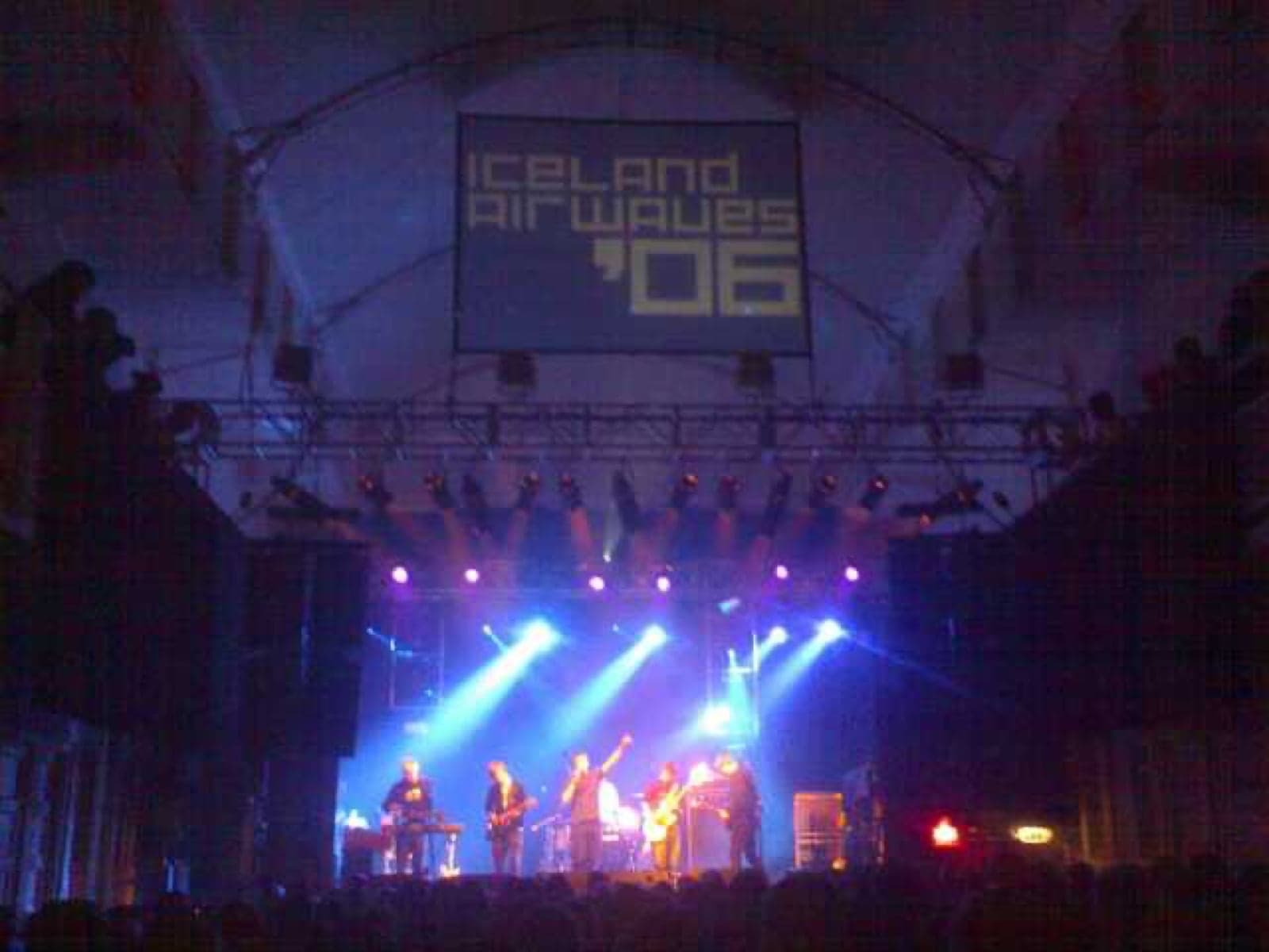 A concert stage with dramatic lights performing Icelandic music