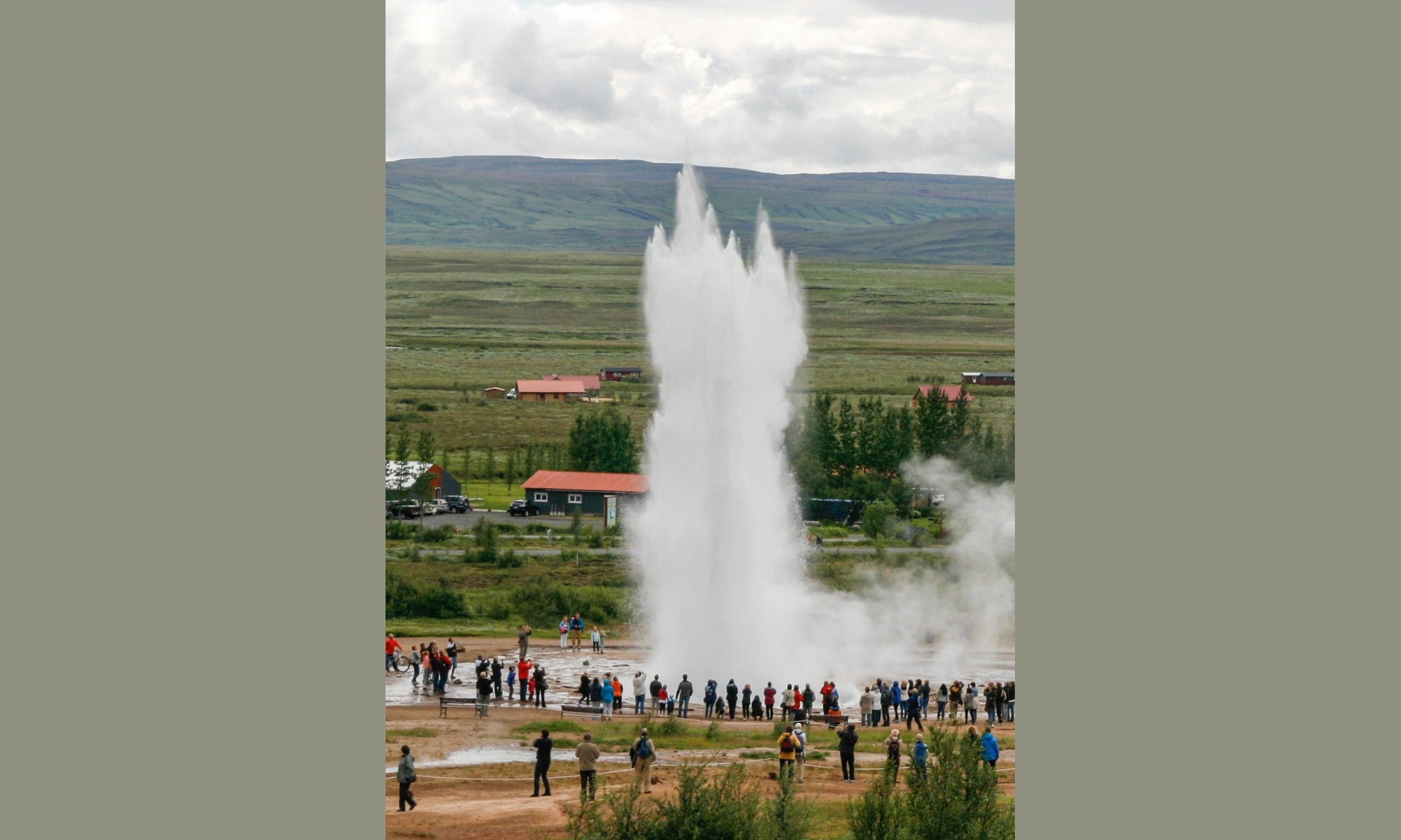 Strokkur geyser erupting in a tall column of boiling water and steam