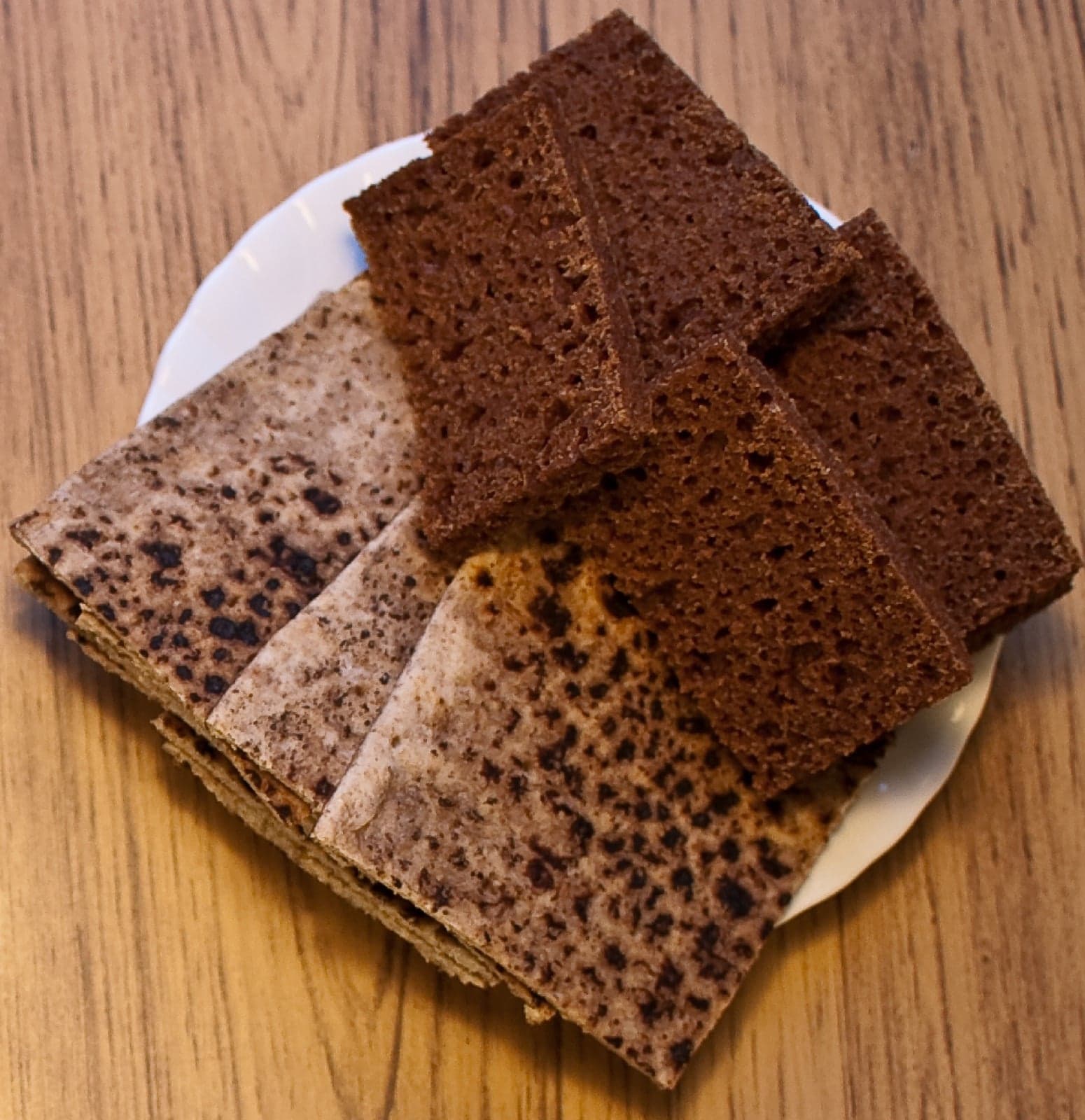 A loaf of dark Icelandic rúgbrauð sliced and topped with butter