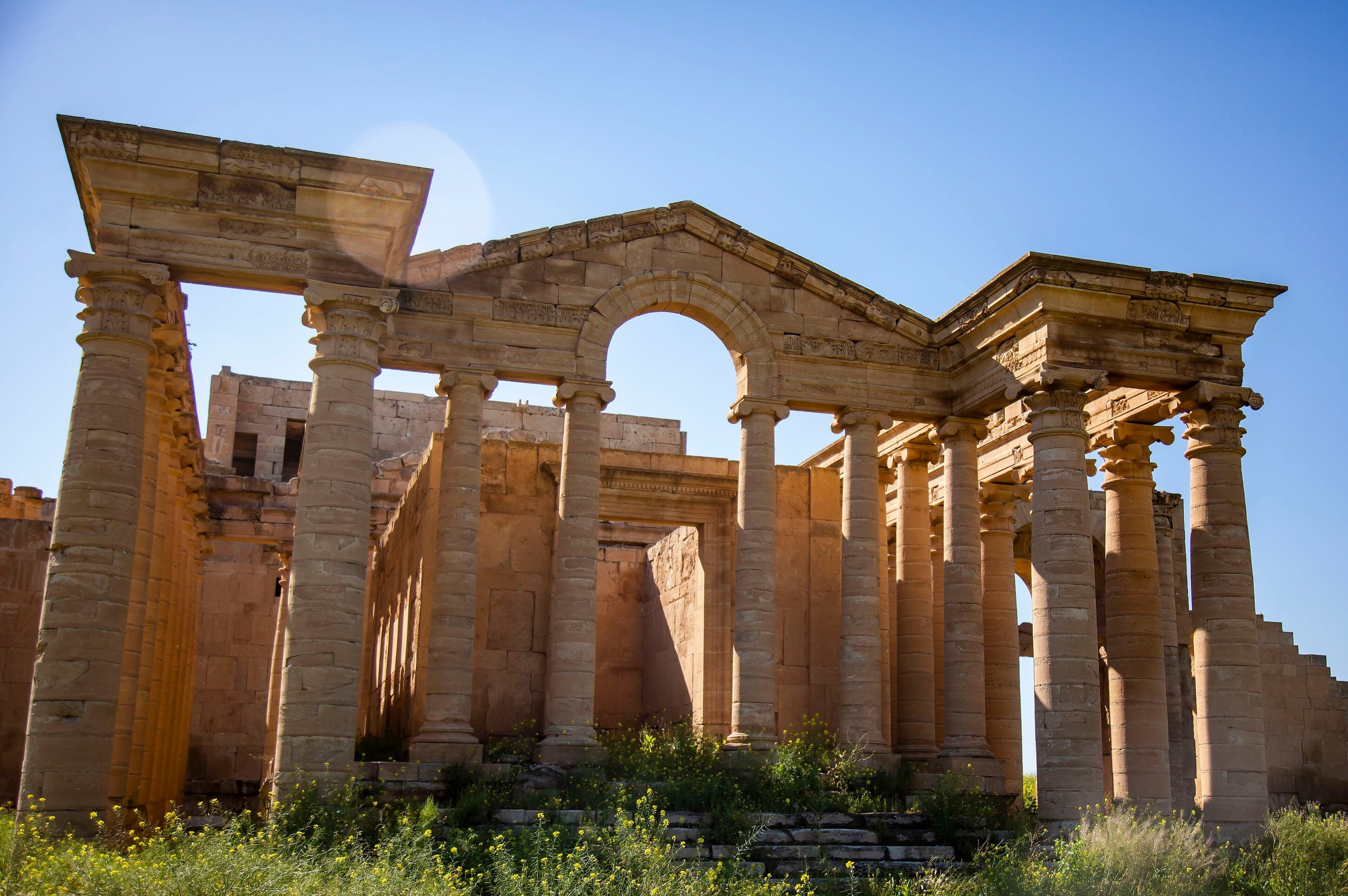 Tall carved stone archways of the ancient desert city of Hatra