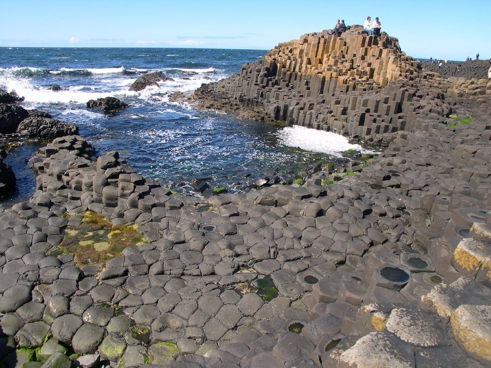 The hexagonal basalt columns of the Giant's Causeway at the edge of the sea