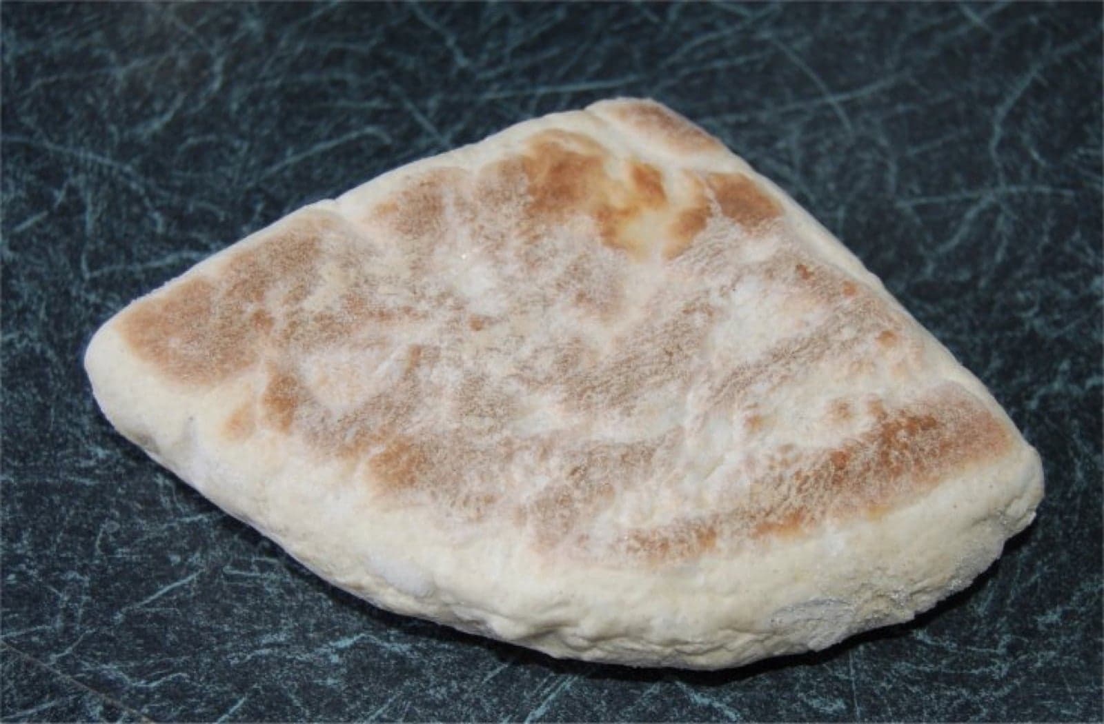 A round loaf of Irish soda bread with a cross cut into the top