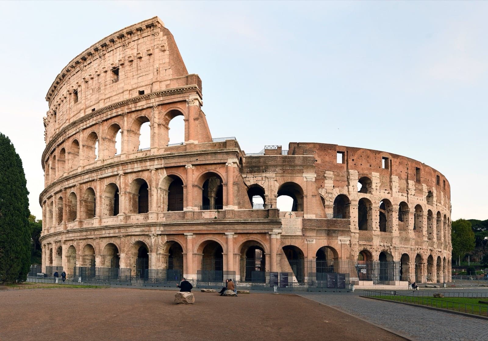 The Colosseum in Rome, with its huge arches glowing in evening light