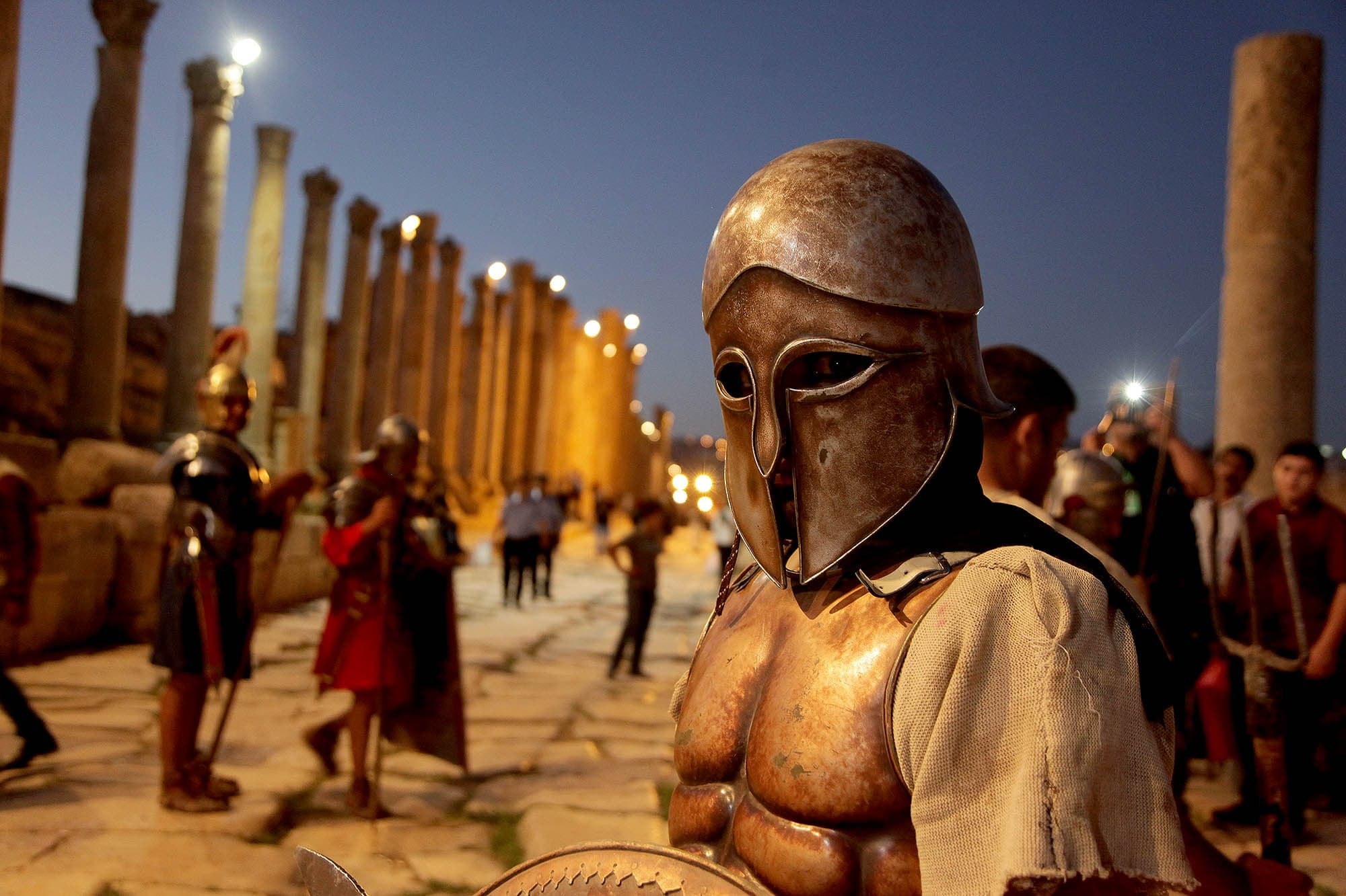 Performers on a floodlit stage inside the ancient Roman south theatre at the Jerash Festival