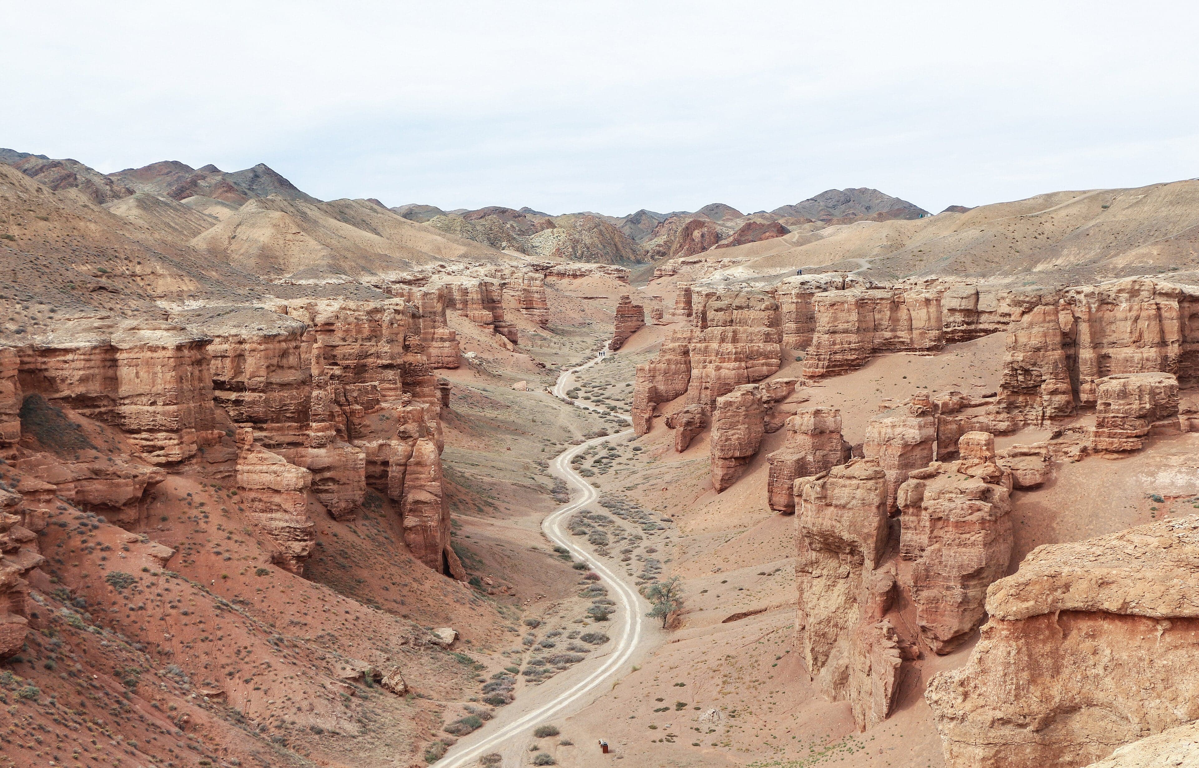 Orange and red rock formations rising from the floor of Charyn Canyon