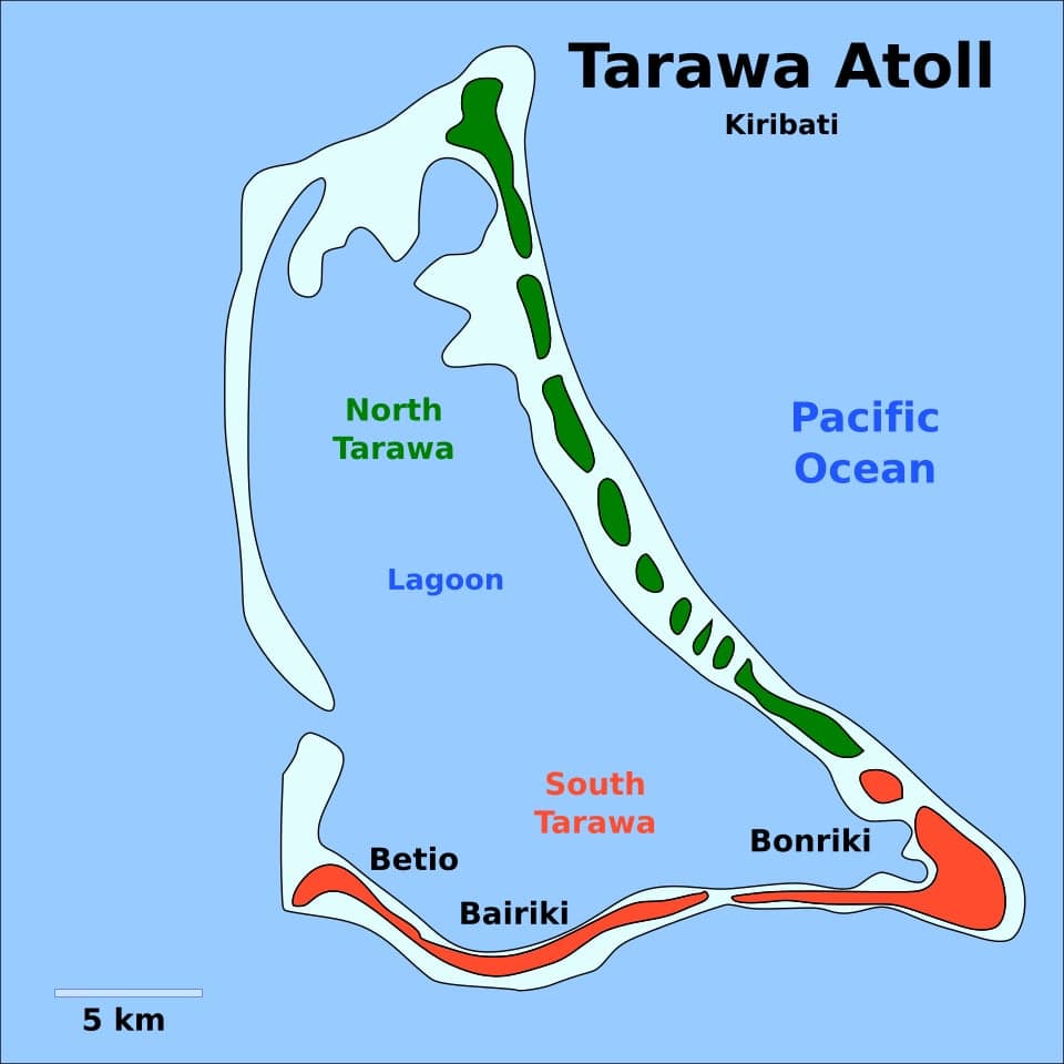 An aerial view of the thin green strip of Tarawa atoll surrounded by blue ocean