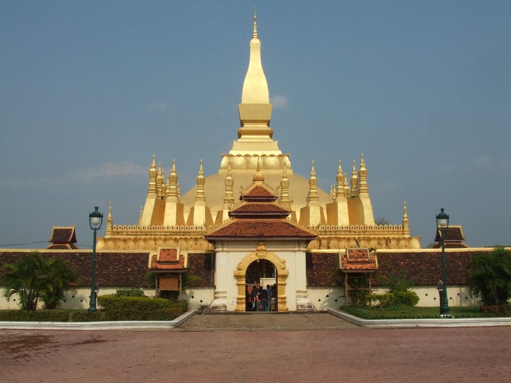 The gold-coloured That Luang stupa rising against a blue sky in Vientiane
