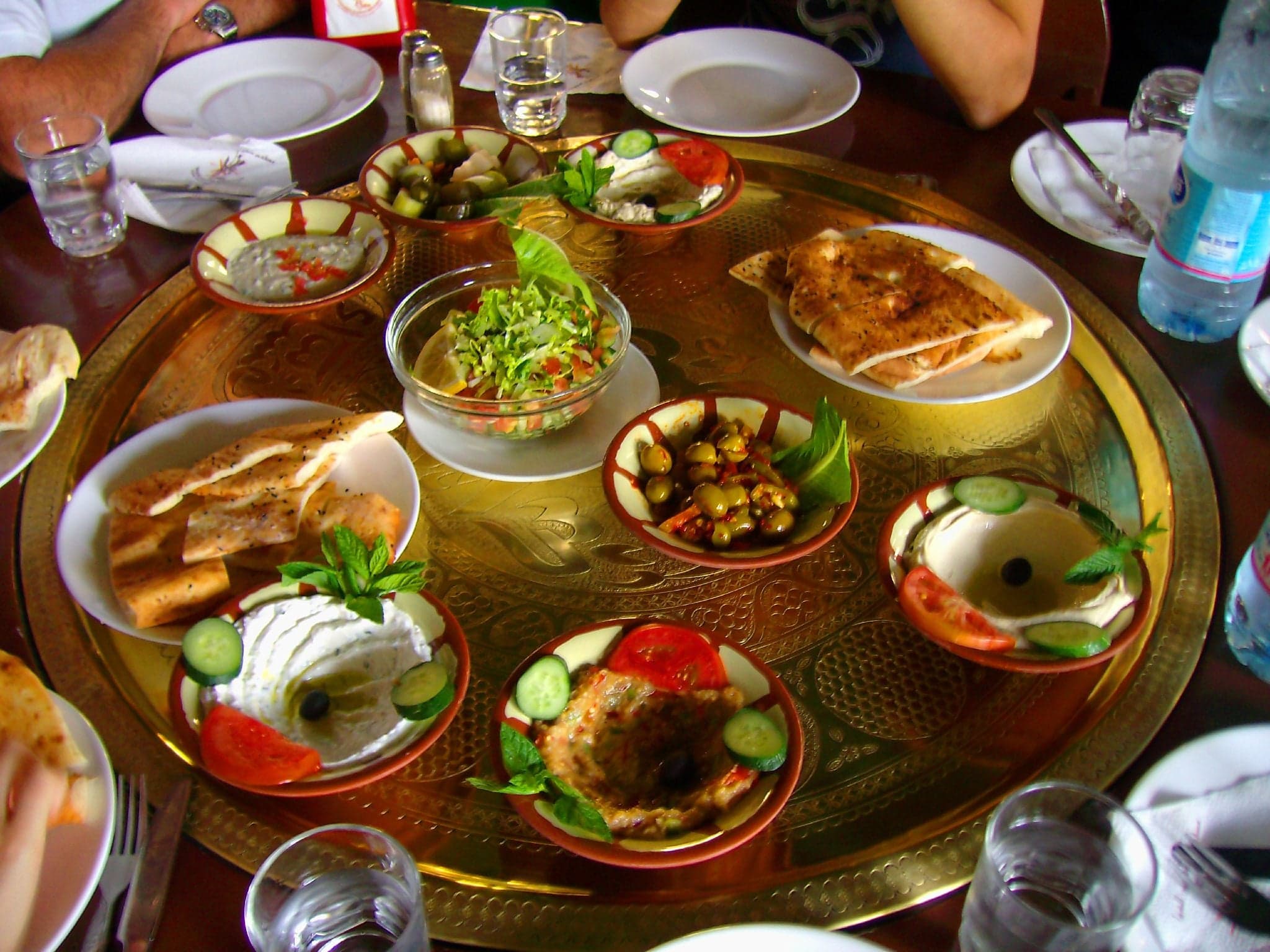 A long table covered with small bowls of Lebanese mezze