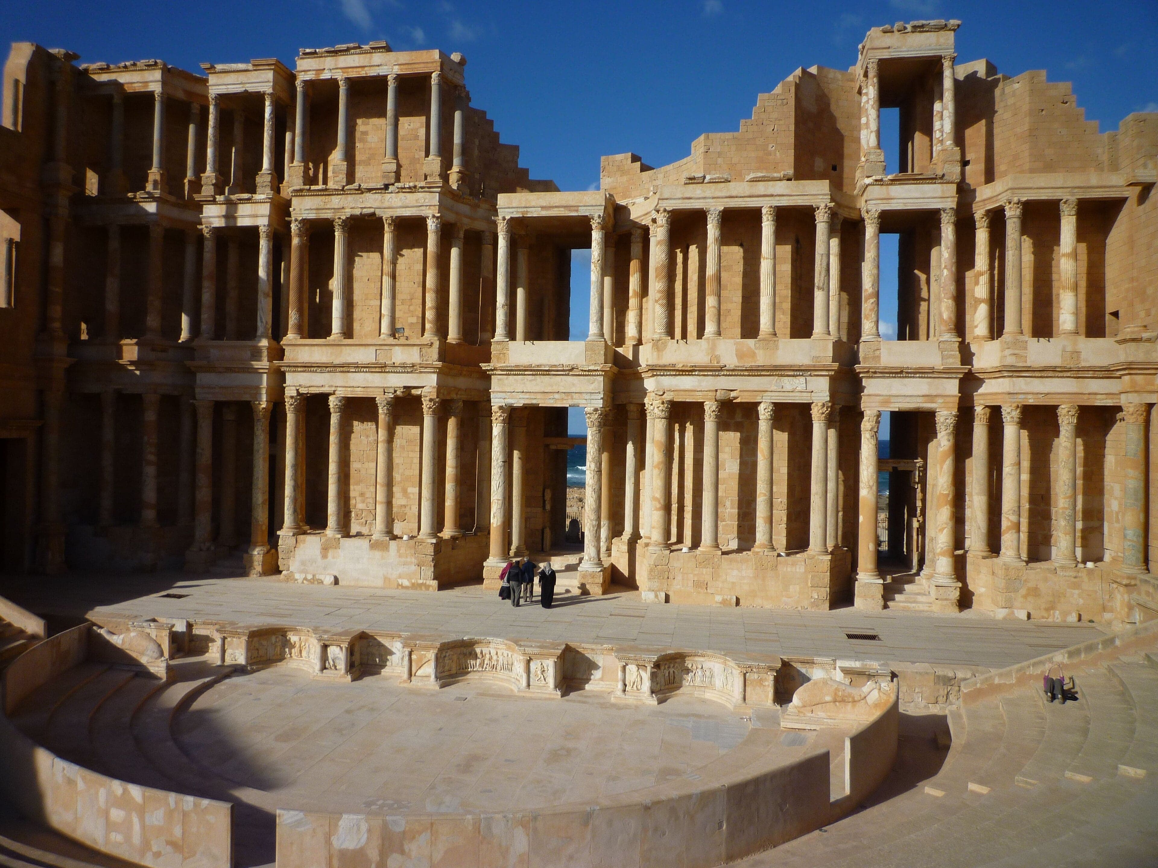 The three-storey stage wall of Sabratha's Roman theatre with the sea behind it