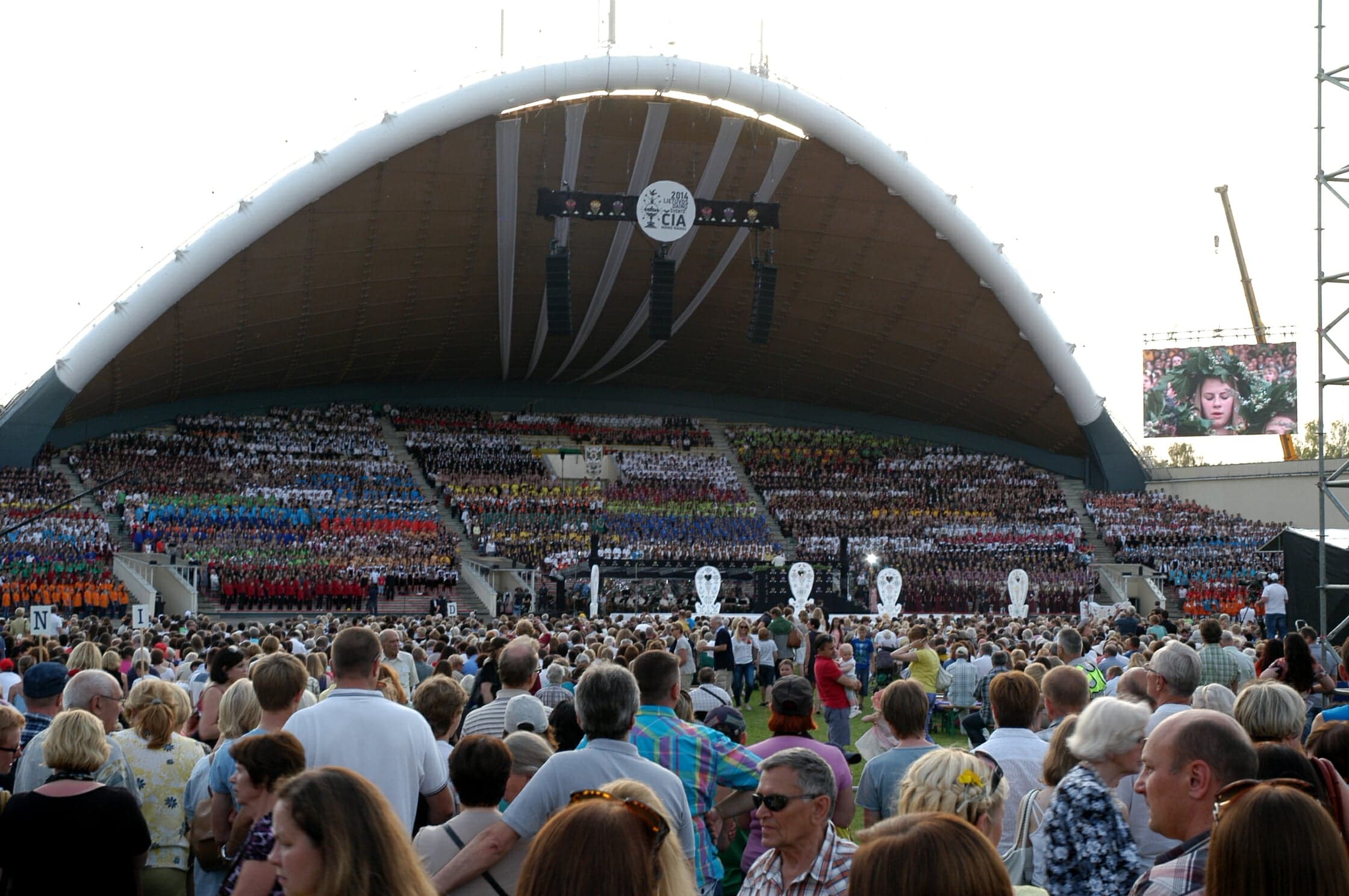 Tens of thousands of singers in traditional costumes performing together at the Lithuanian Song Festival