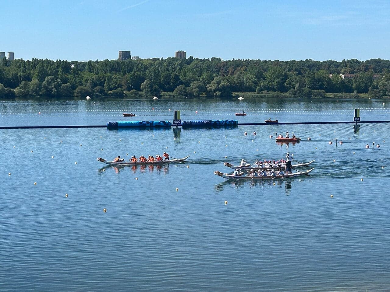 Dragon boat racing team paddling hard in a colourful painted dragon boat on the water