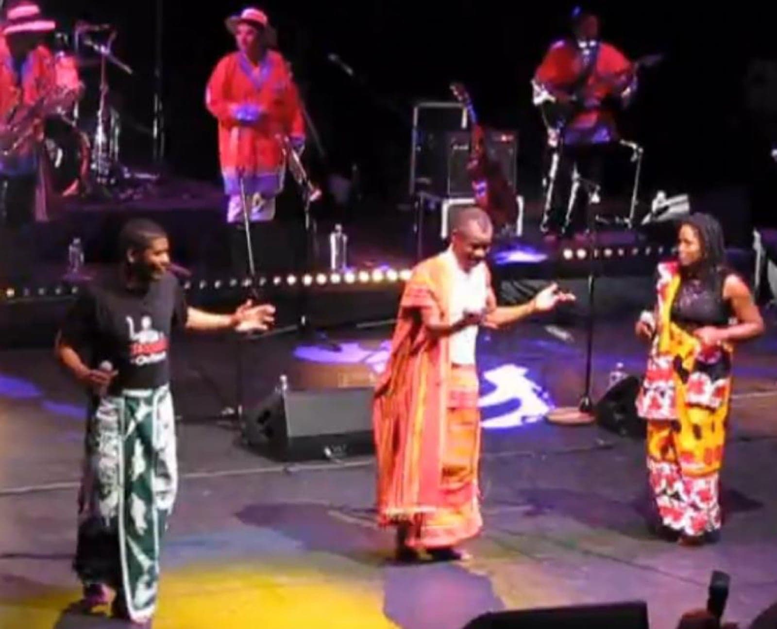 A salegy musician performing on stage with a band
