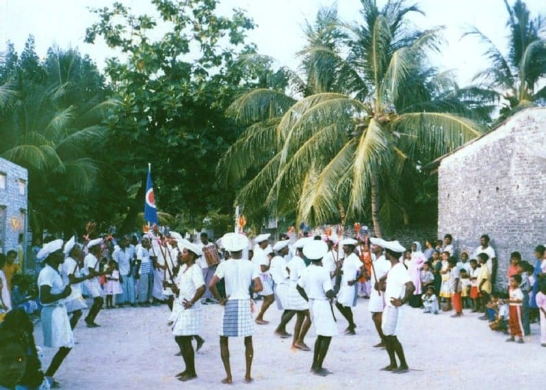 Men playing large cylindrical drums at a traditional bodu beru performance