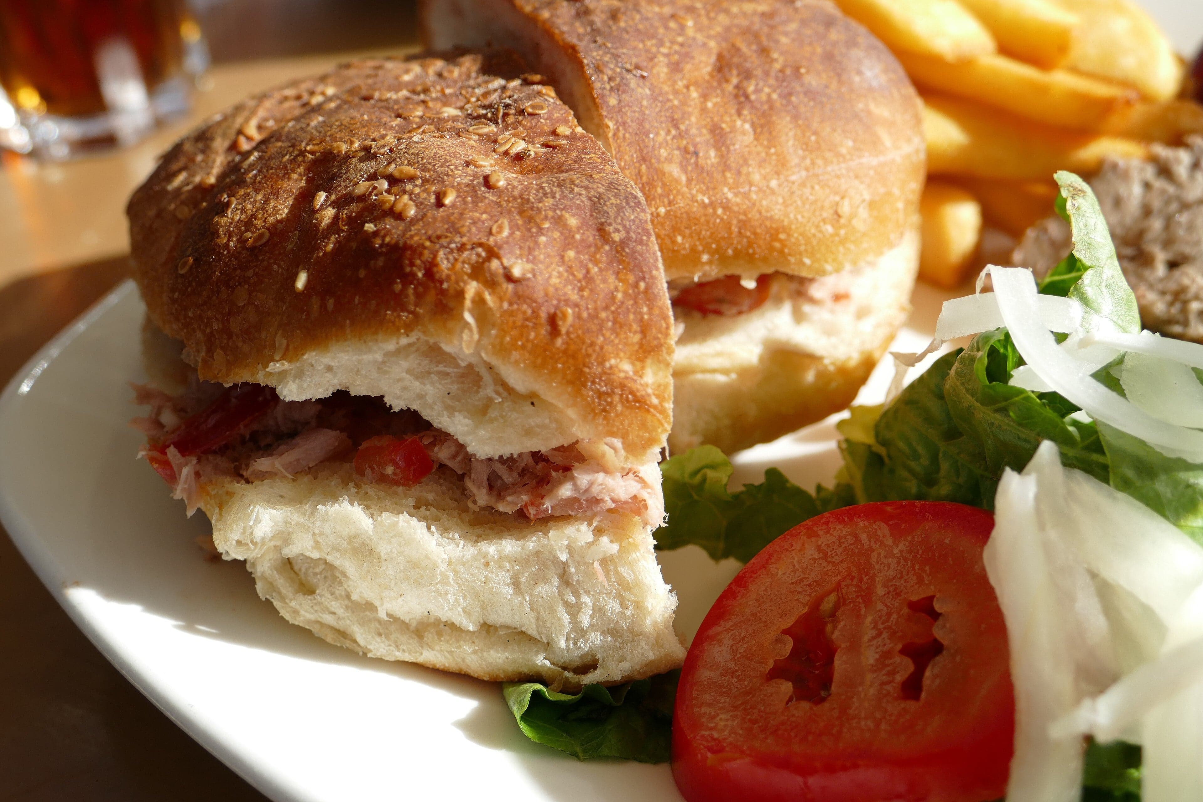 A traditional Maltese ftira sandwich filled with tomatoes and tuna