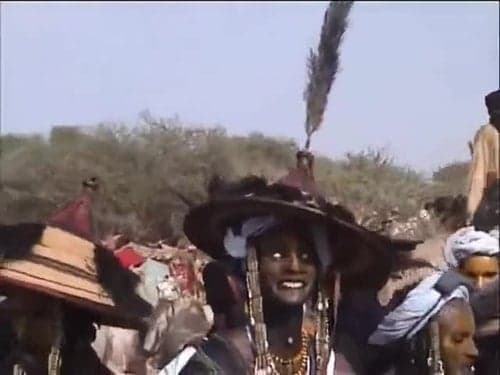Tuareg women playing tindé drums at a night gathering under the stars
