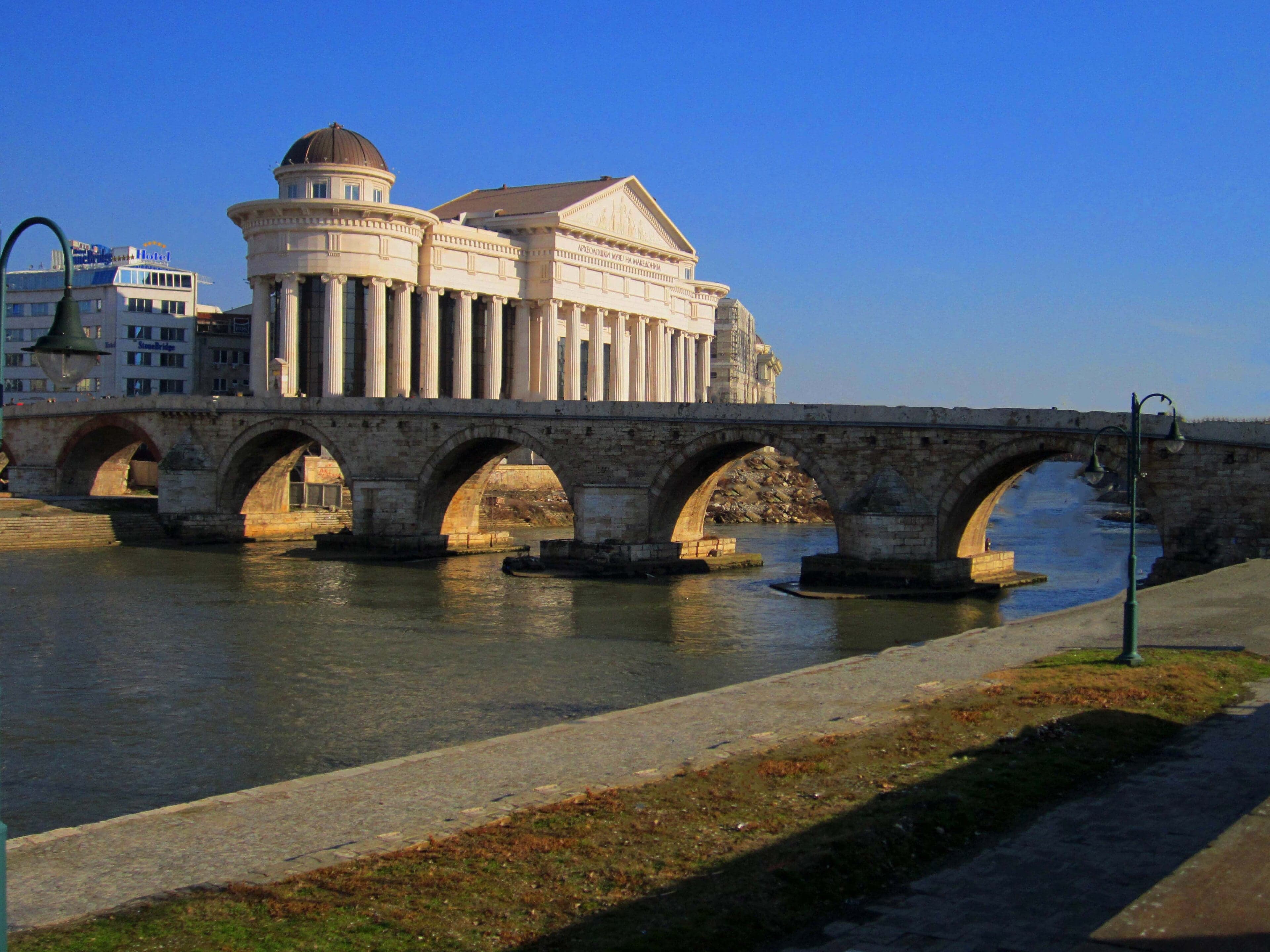 The Stone Bridge of Skopje arching over the Vardar River with the city behind it