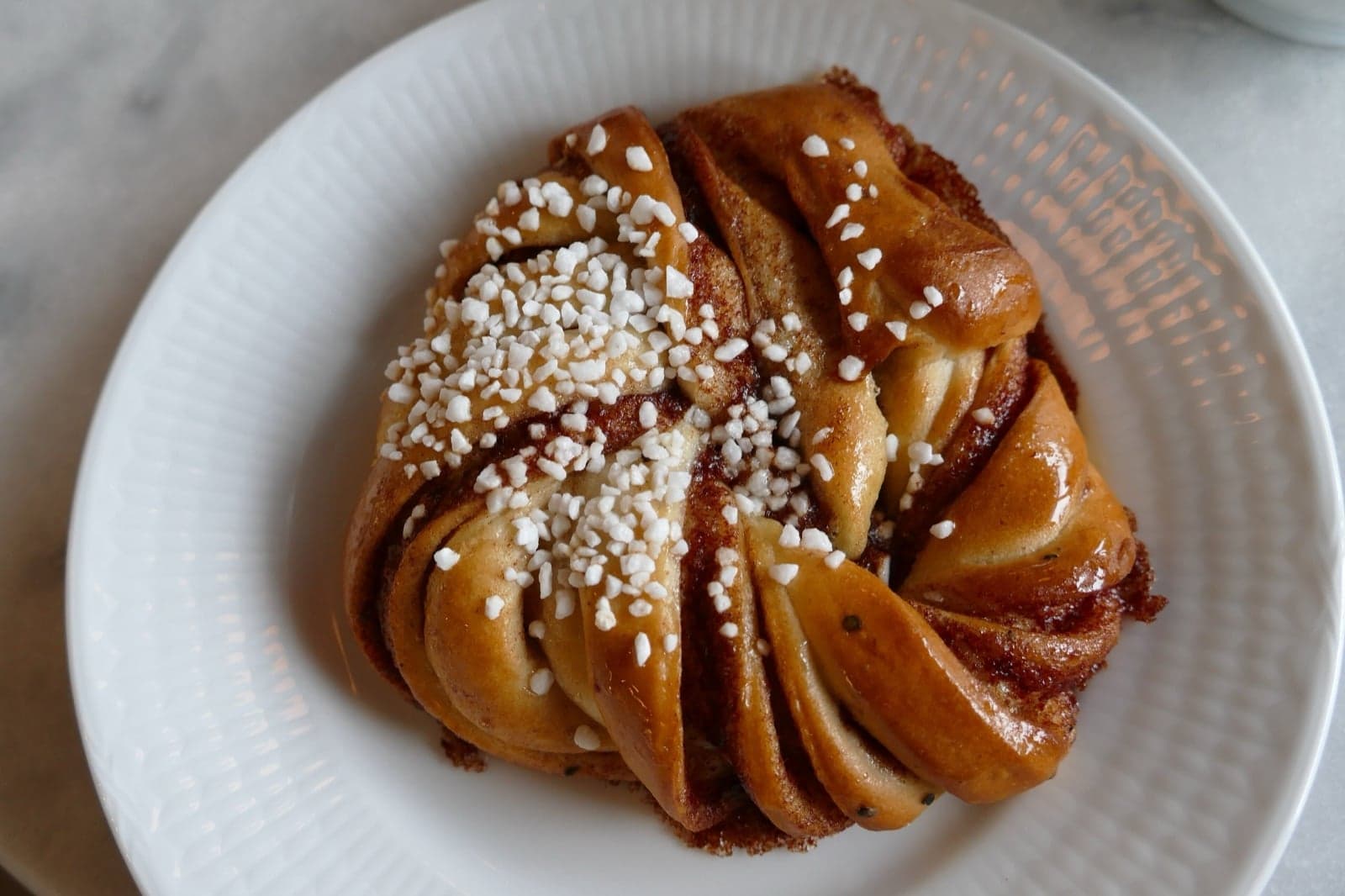 Freshly baked Norwegian cinnamon buns (kanelboller) on a wooden board