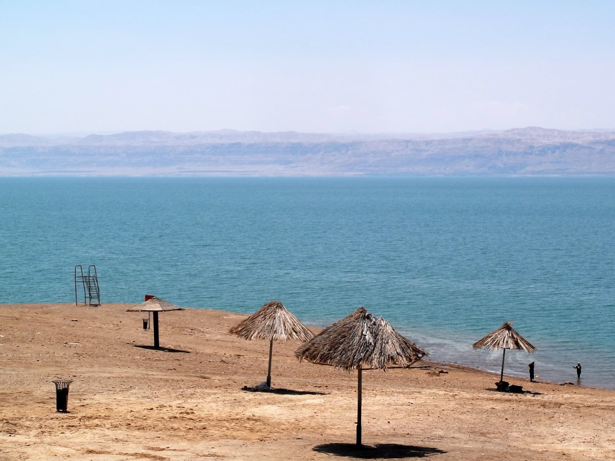 A person floating effortlessly on the glassy surface of the Dead Sea